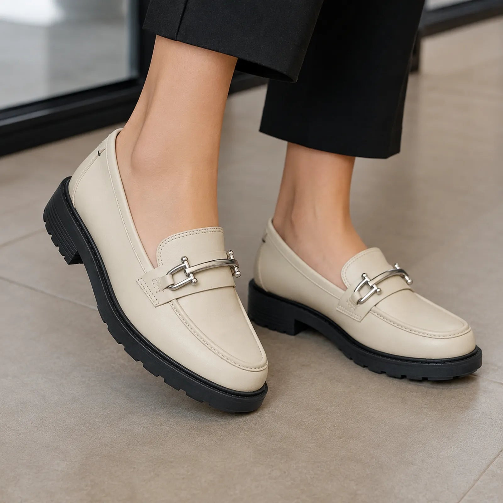 Ivory leather loafers with silver metal strap detail and low tread block heels