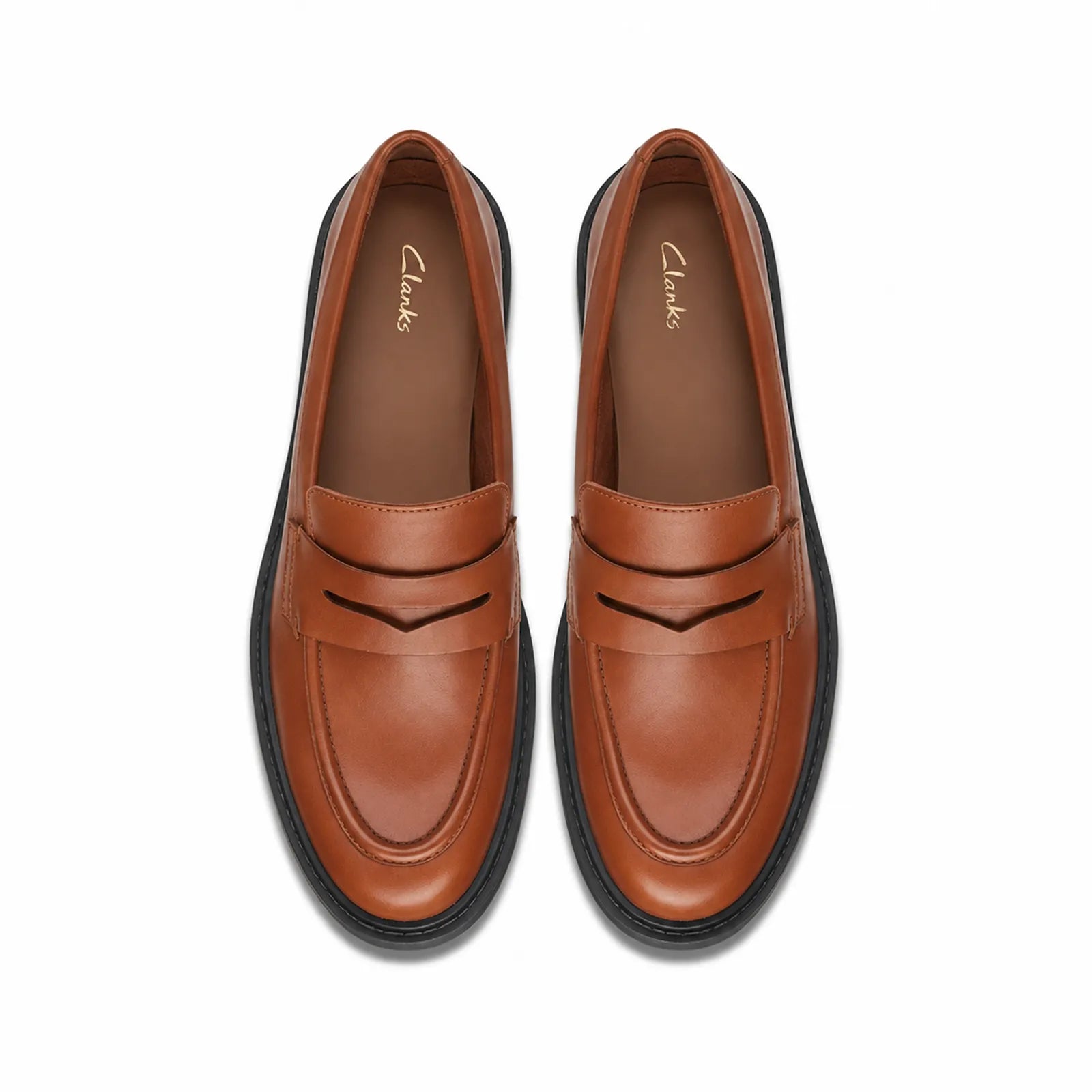 Pair of brown leather women's penny loafers with penny strap and rubber sole