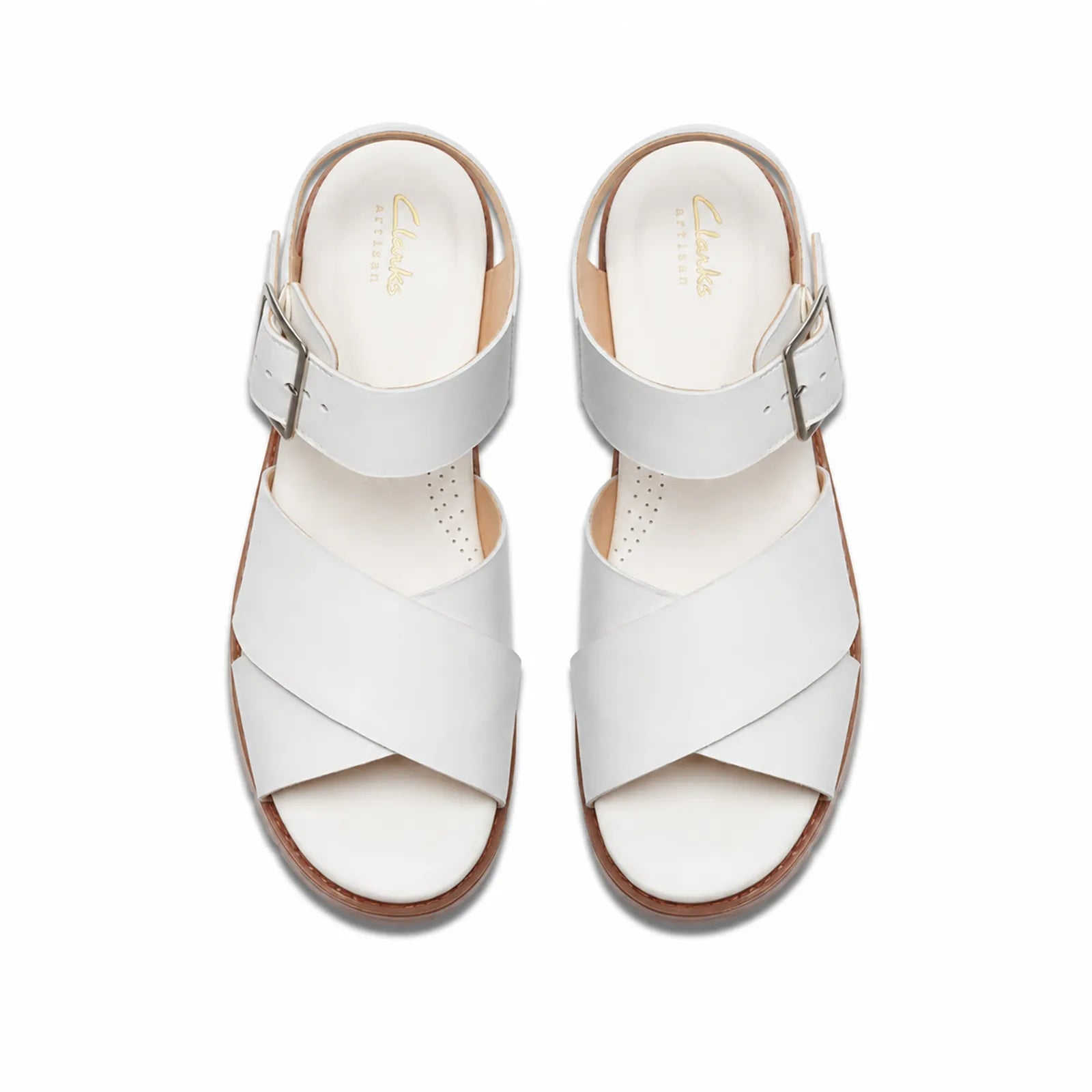Pair of cream white leather sandals with crisscross straps and adjustable buckle