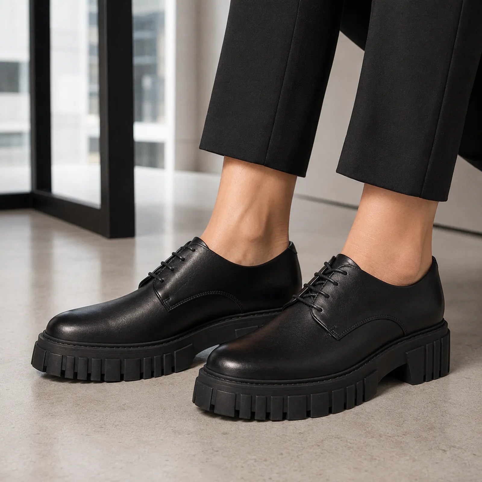 Women's black leather oxford-style lace-up shoes with platform lug sole