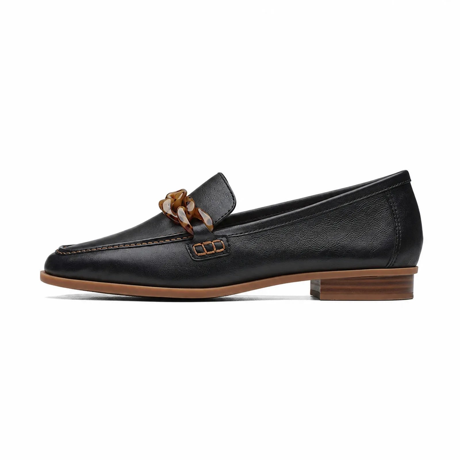 Women's black leather loafer with braided chain bit, side profile, tan sole edge