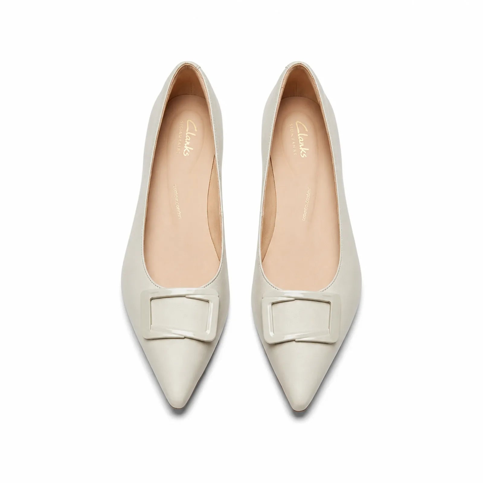 Pair of white women's pointed-toe loafers with buckle strap