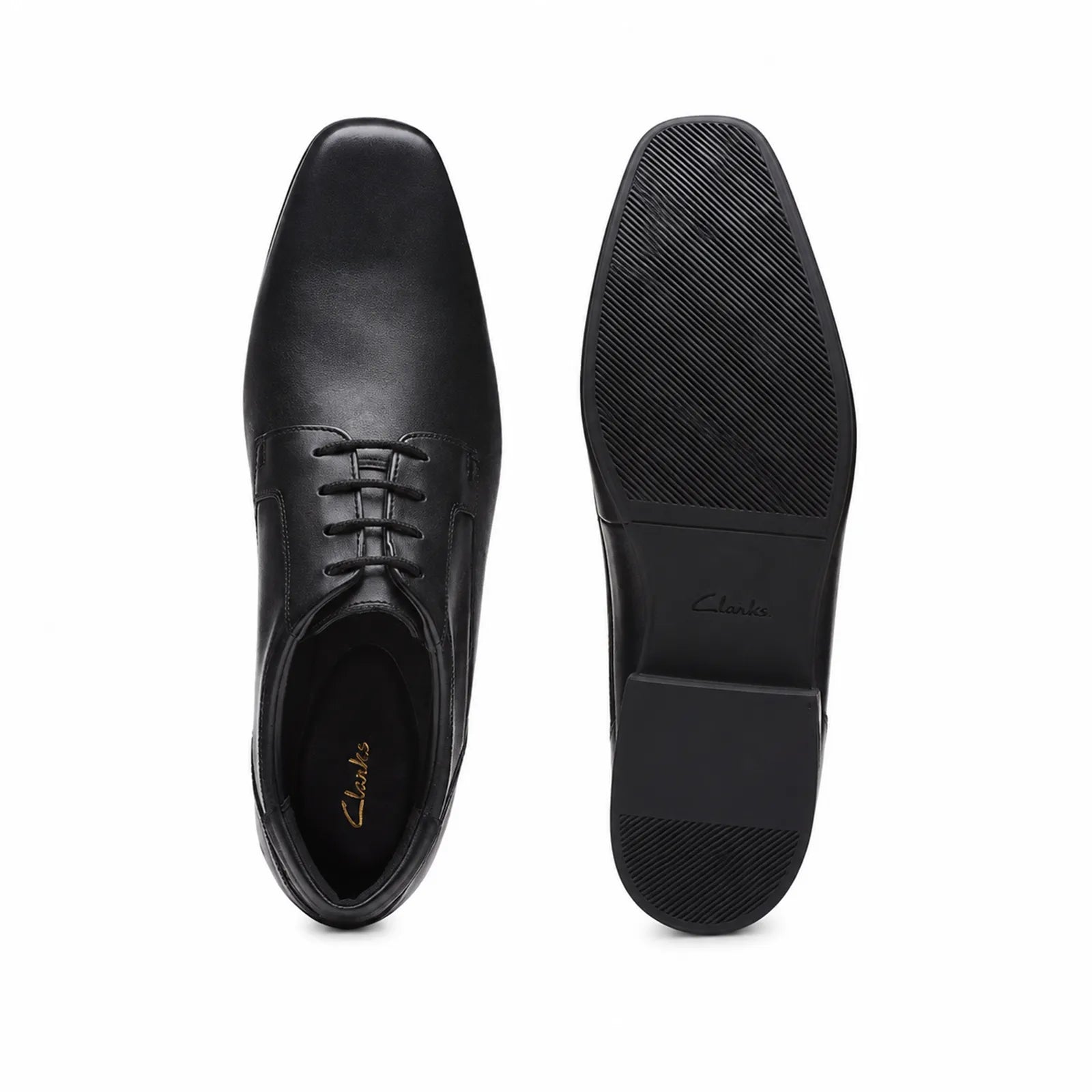 Pair of men's black leather lace-up business shoes, front view and textured outsole