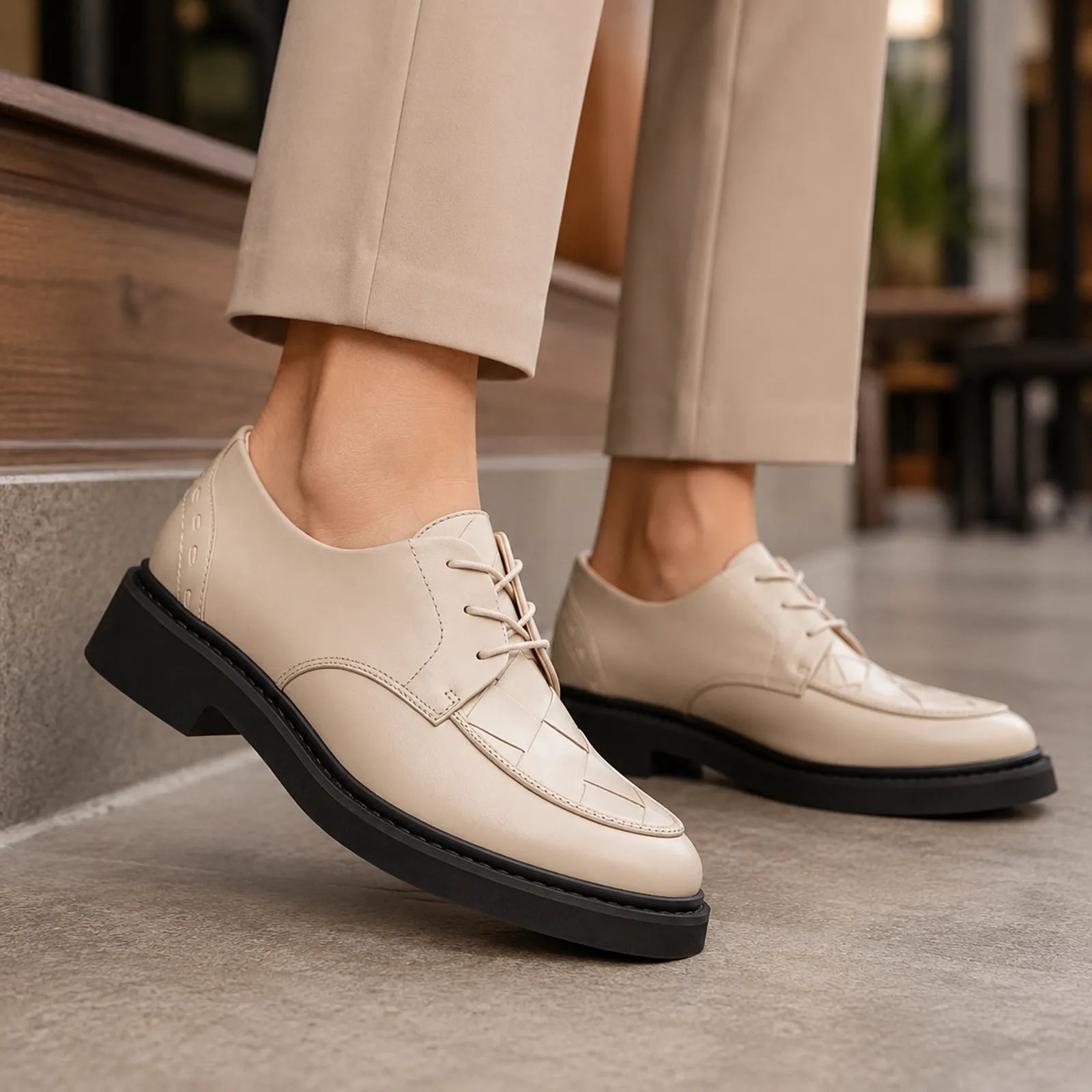 Pair of women’s white leather lace-up business shoes with chunky black platform sole