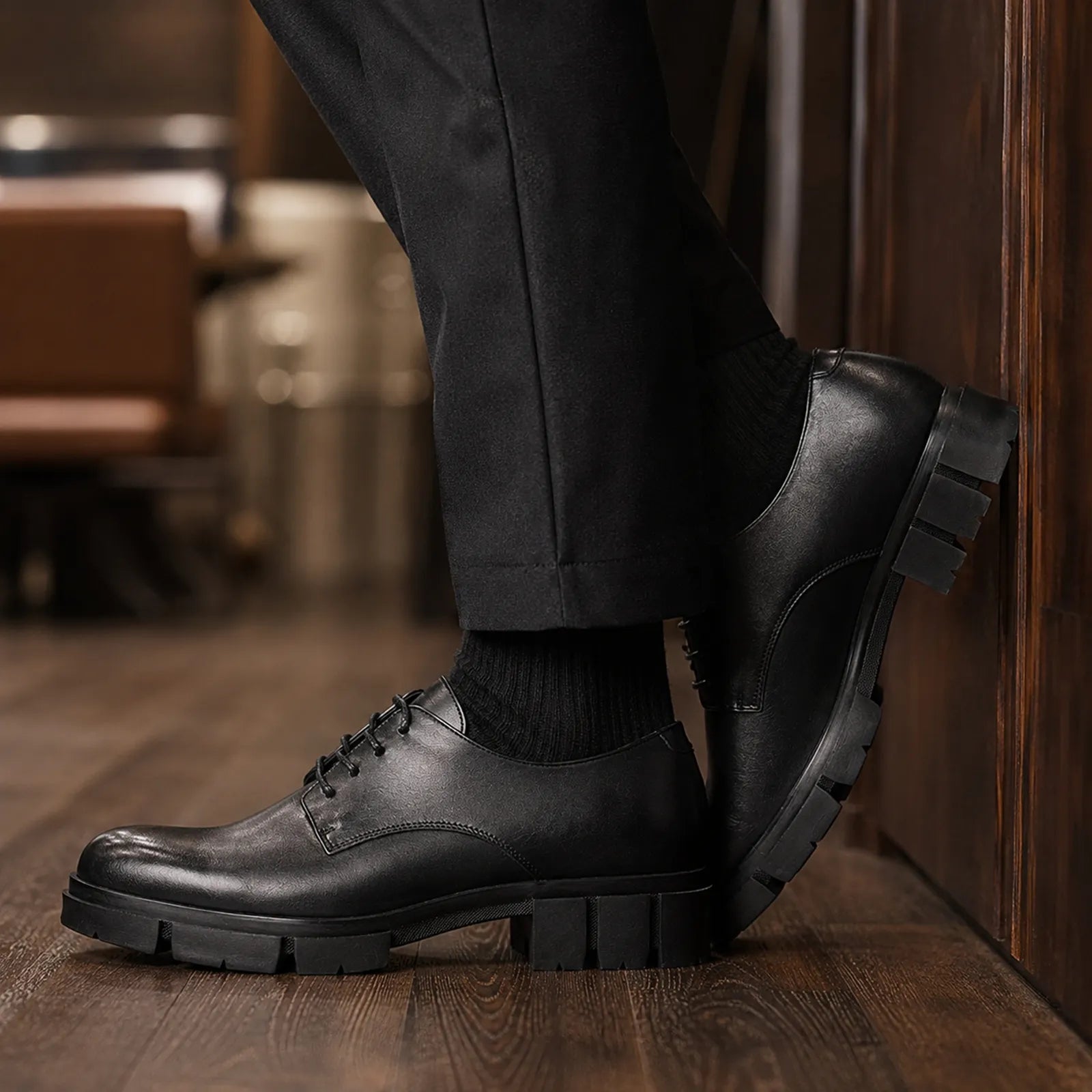 Black leather lace-up shoe with side strap detail and chunky block heel.
