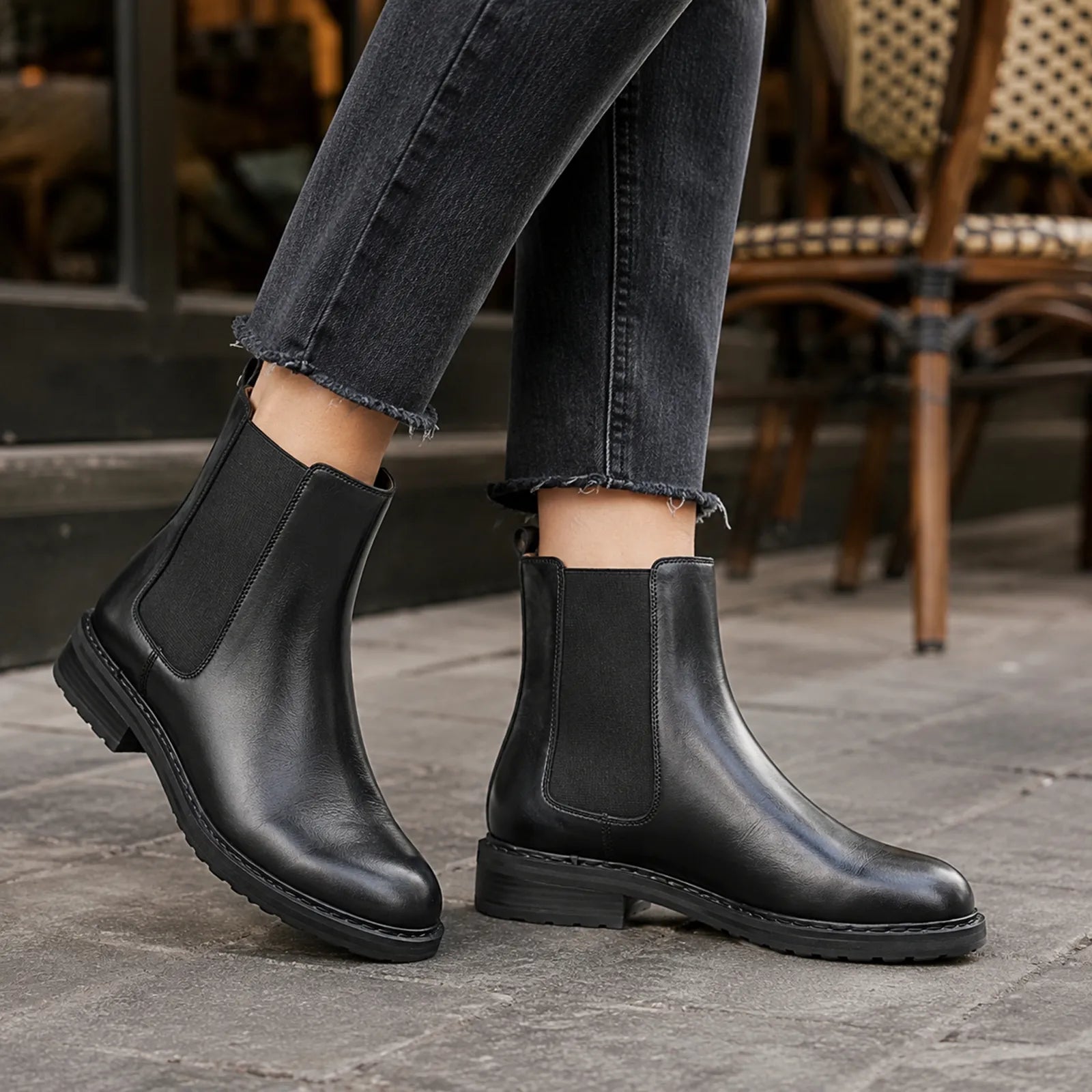 Black Chelsea boots with elastic side panels and rugged tread sole