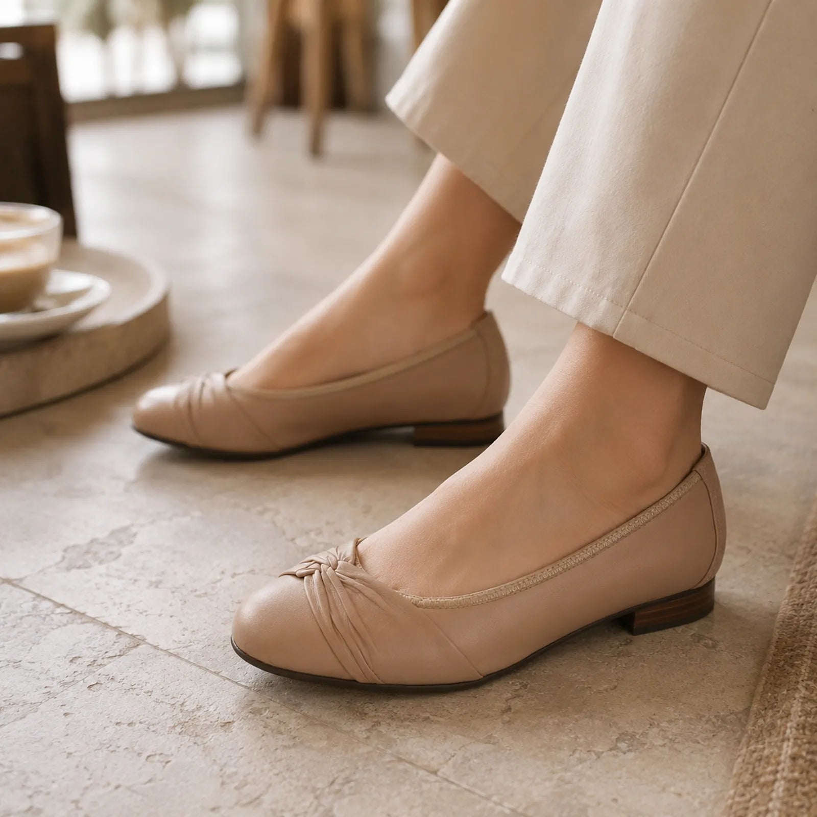 Women’s beige leather flats with pleated bow at toe and low block heel