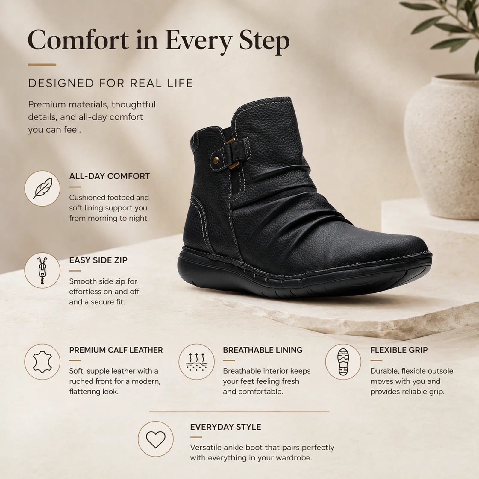 Women’s black leather ankle boot with side zip and buckle strap