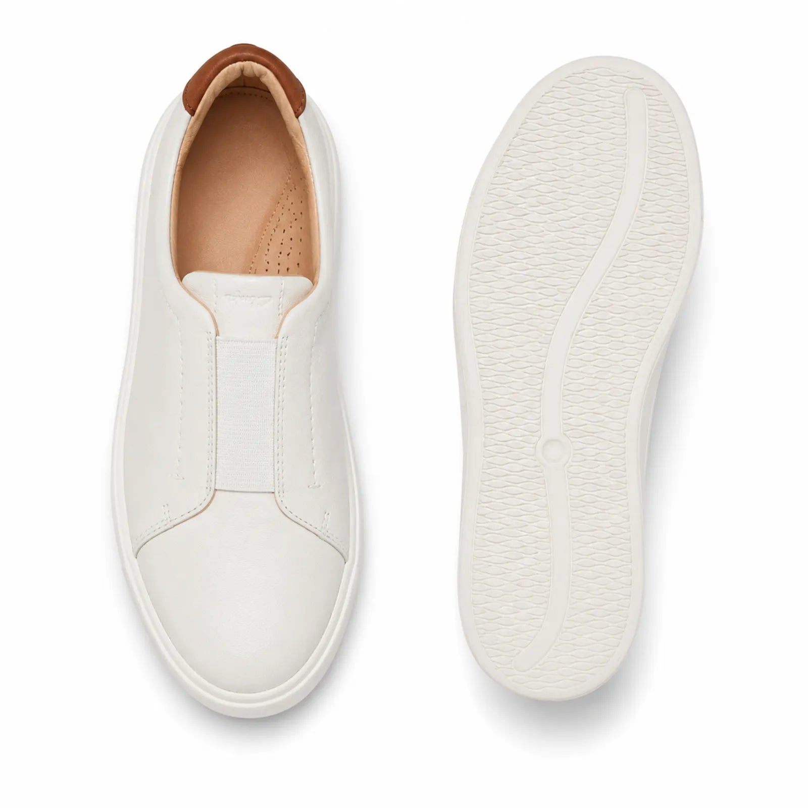 White leather slip-on sneakers, showing opening and textured outsole view.