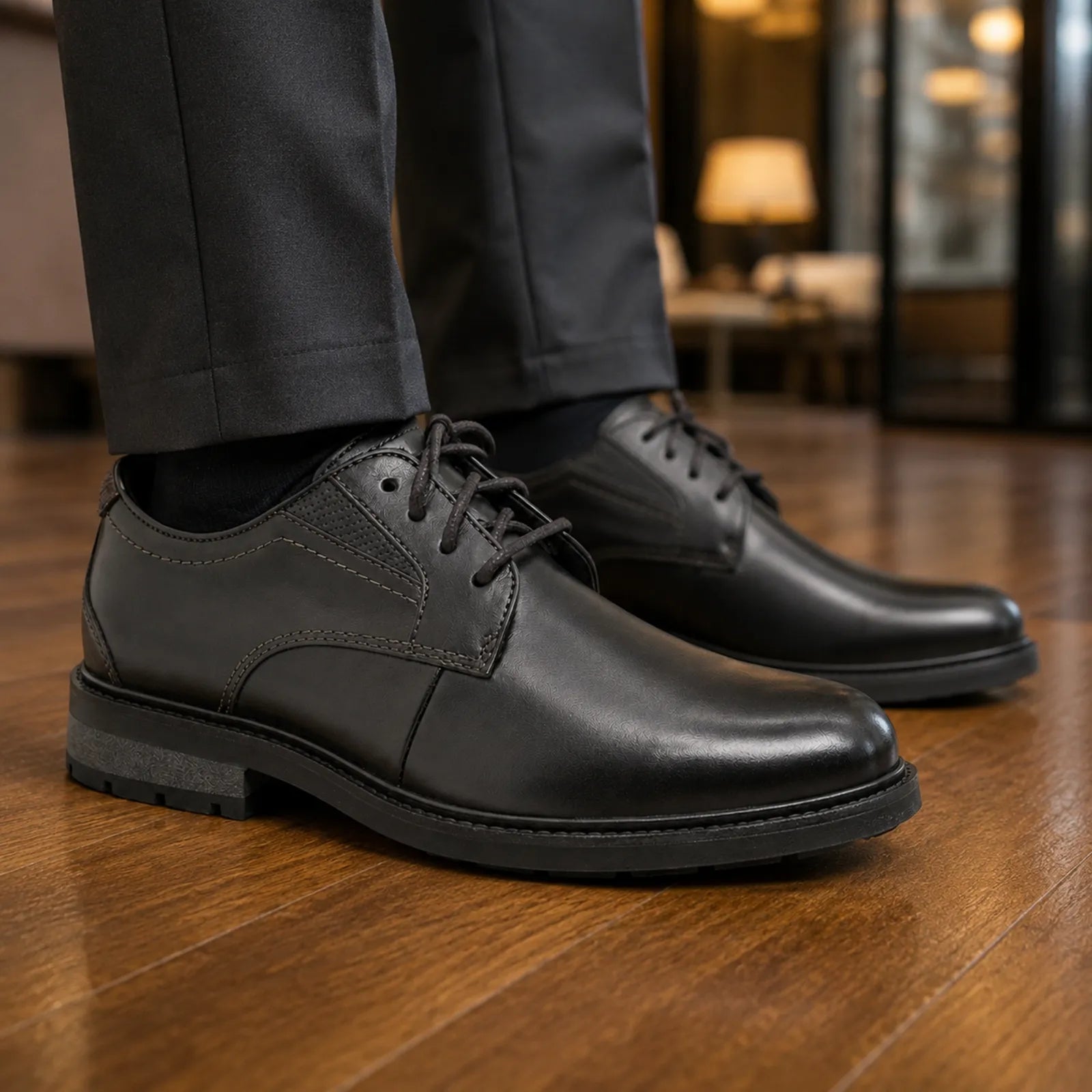 Pair of men's black leather lace-up business shoes with chunky rubber sole