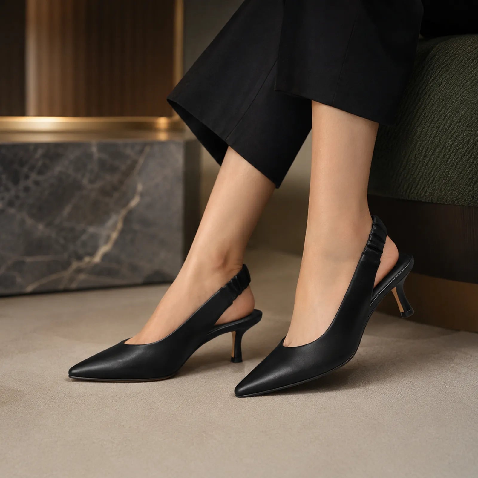 Black pointed-toe slingback pumps with ruched strap and high stiletto heels