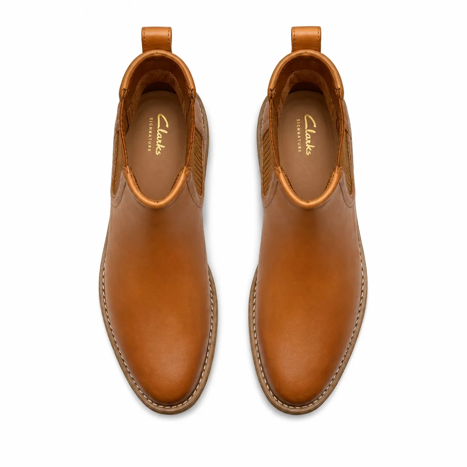 Pair of brown leather chelsea ankle boots with elastic gore and cushioned tread sole