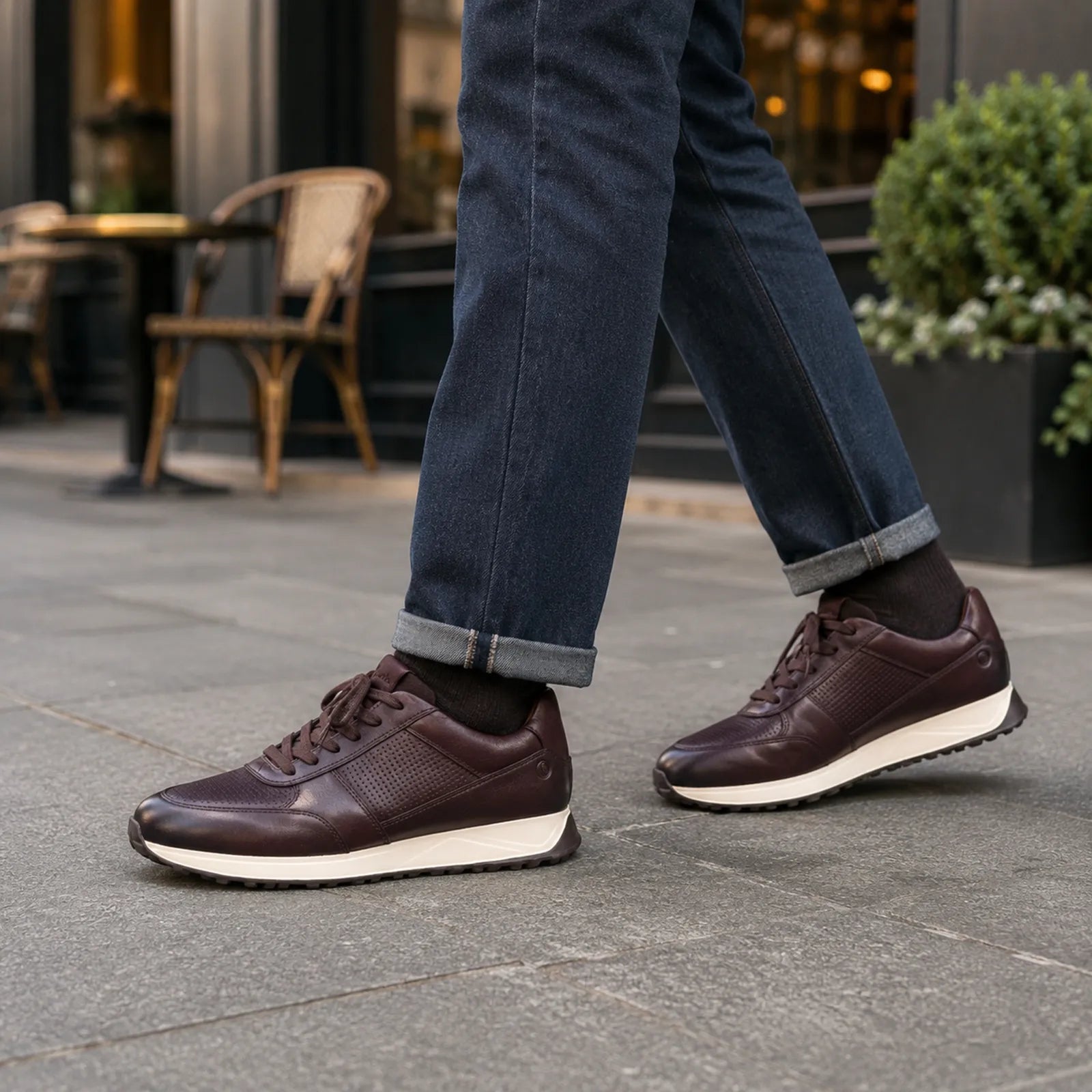 Brown leather lace-up sneakers with white outsole and low-profile, textured upper