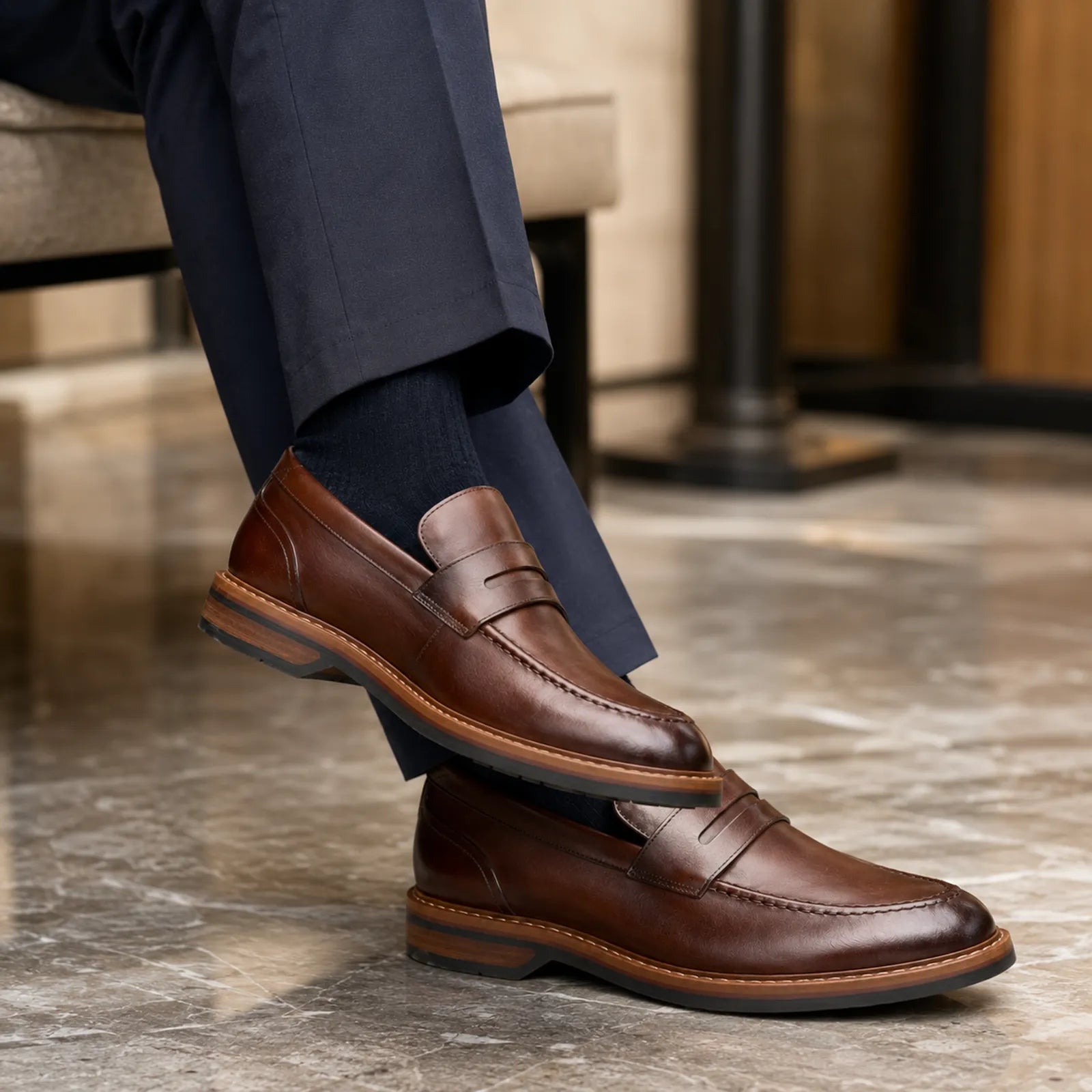 Brown leather men’s loafer with strap detail, stitched seam and rugged sole