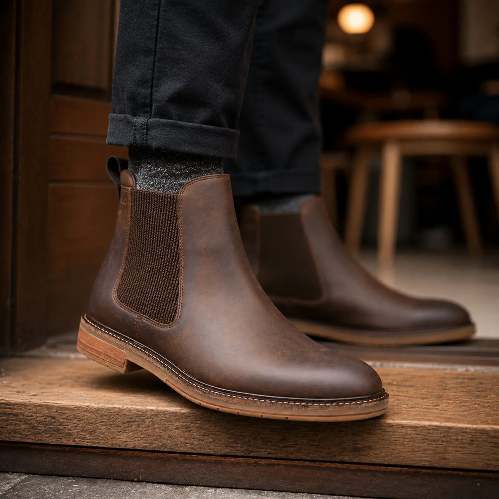 Brown leather chelsea boot close-up, elastic gore and stitched low sole