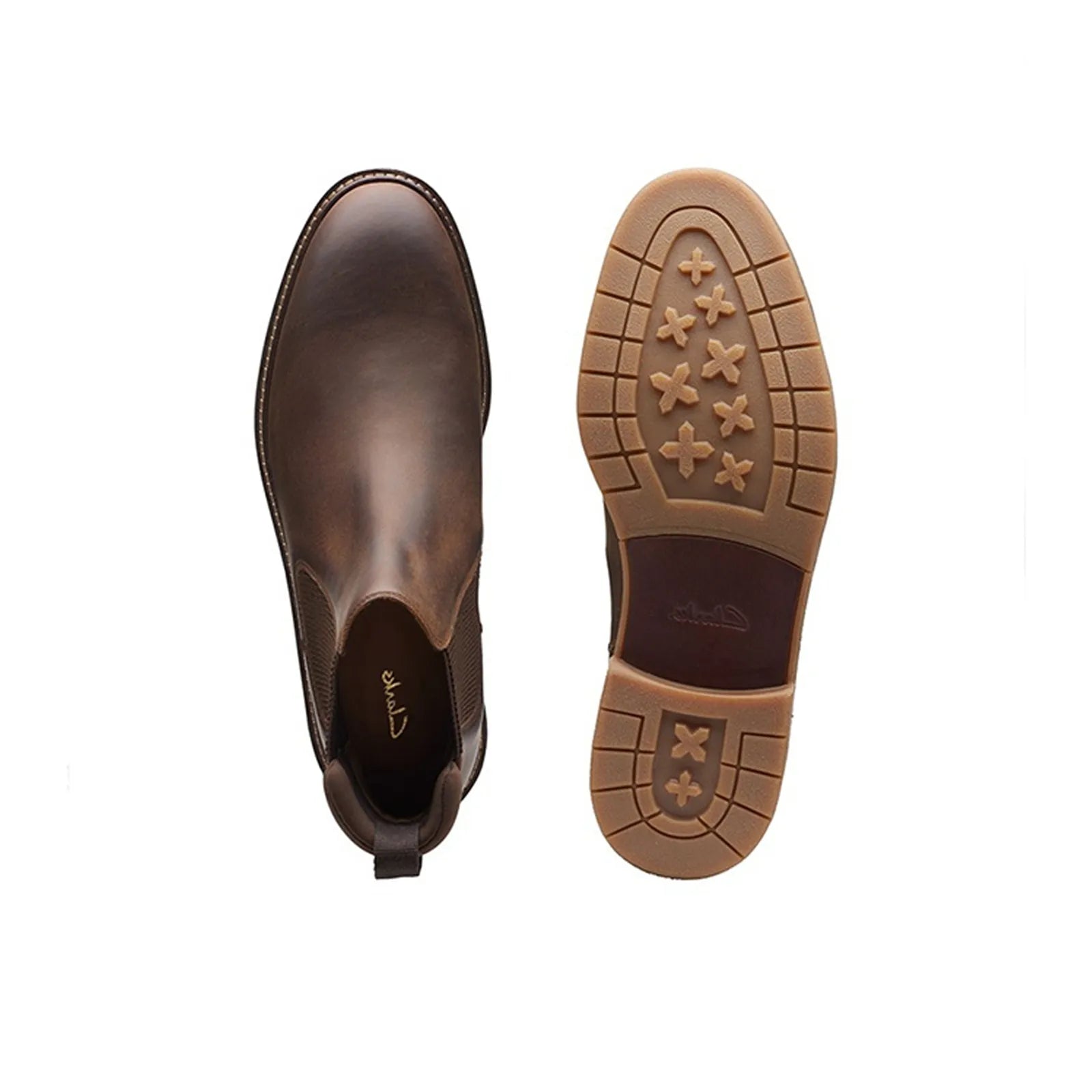 Pair of brown leather chelsea boots with elastic gore, outsole view underneath