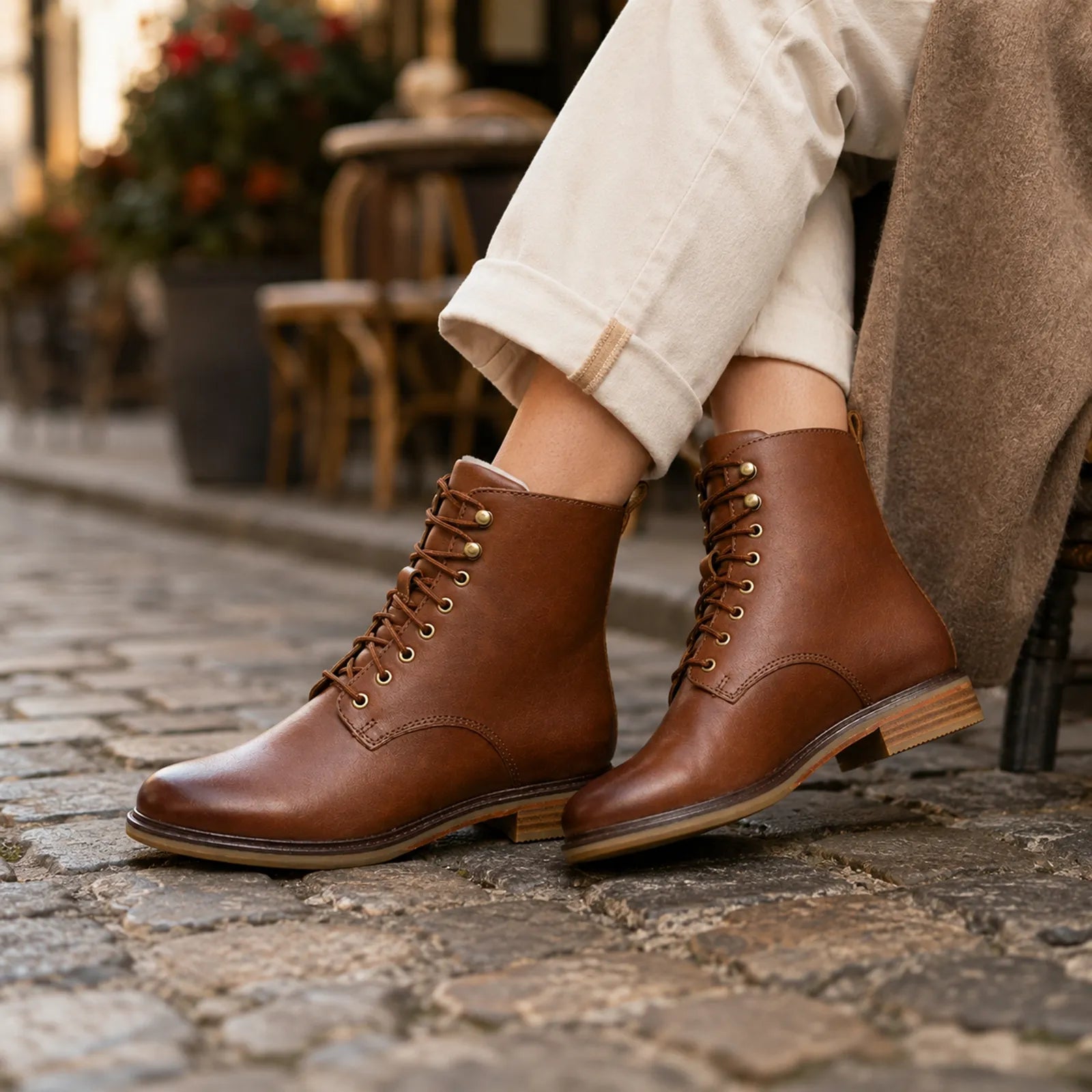 Dark brown leather lace-up ankle boots with stitched detailing and low heel sole.