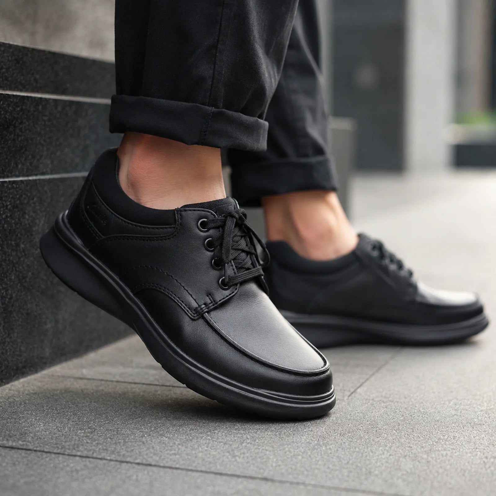 Men’s black leather lace-up shoe with rubber sole, side view
