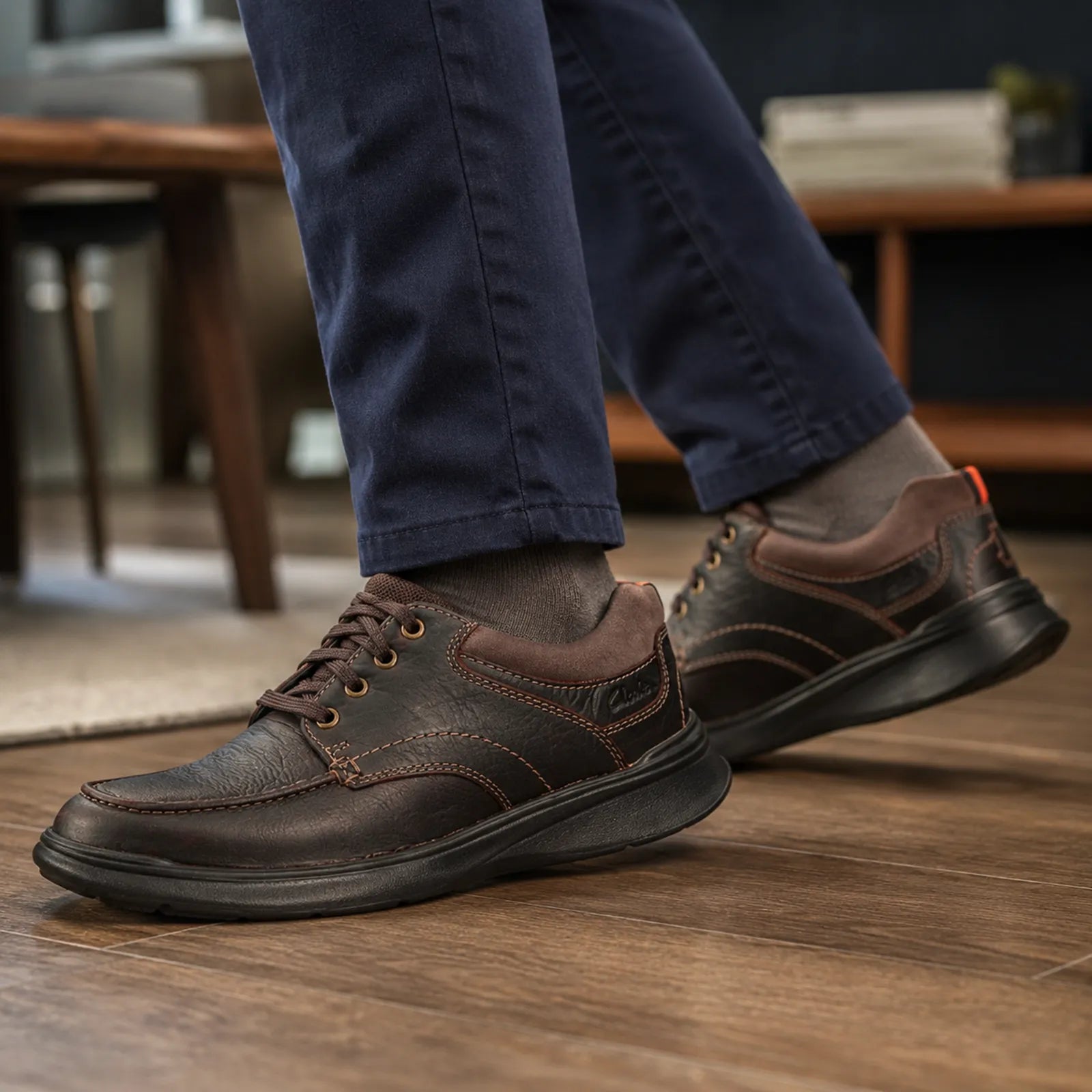 Men’s dark brown leather lace-up shoes with decorative stitching and rubber sole