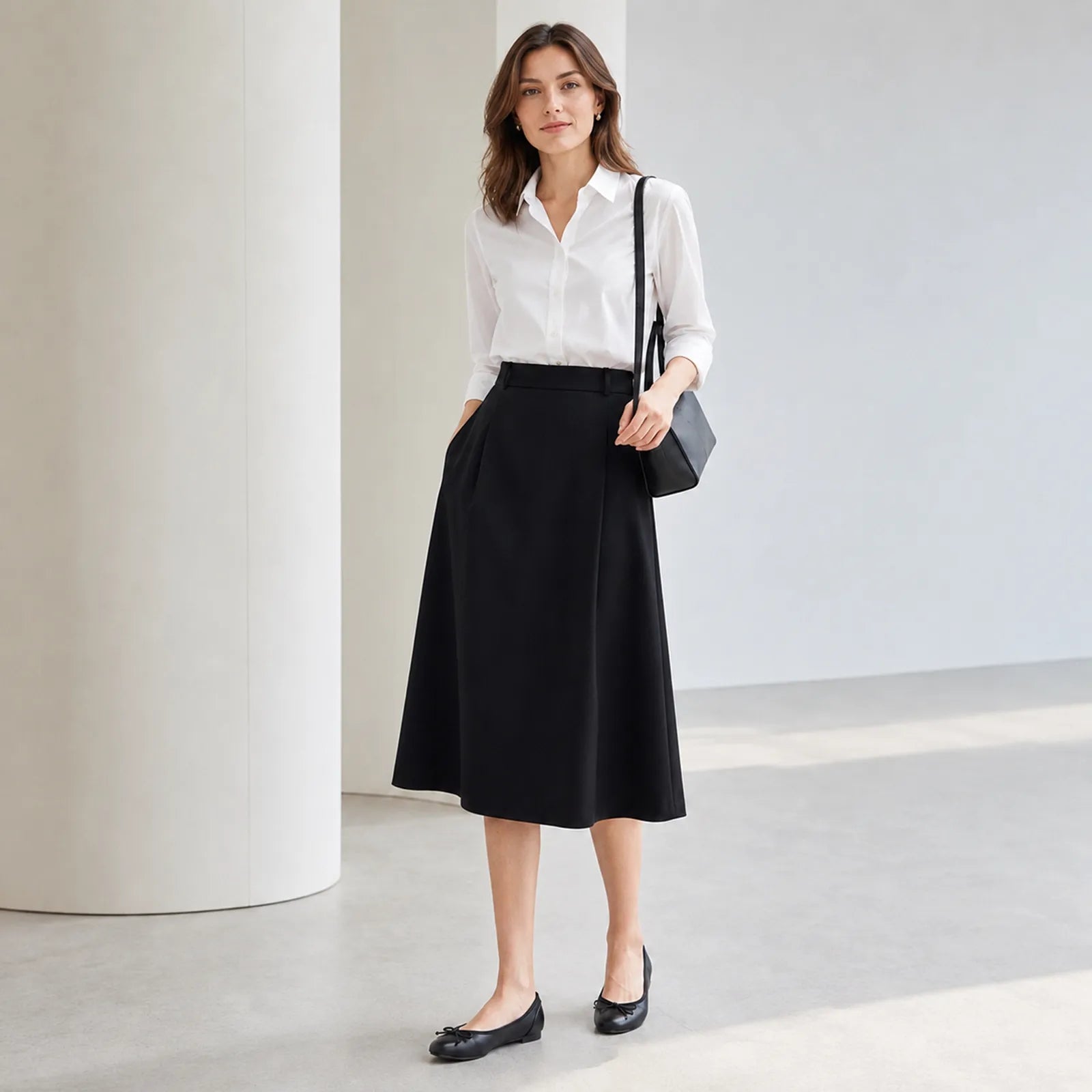 Black leather ballet flats with bow tie, worn with a midi skirt