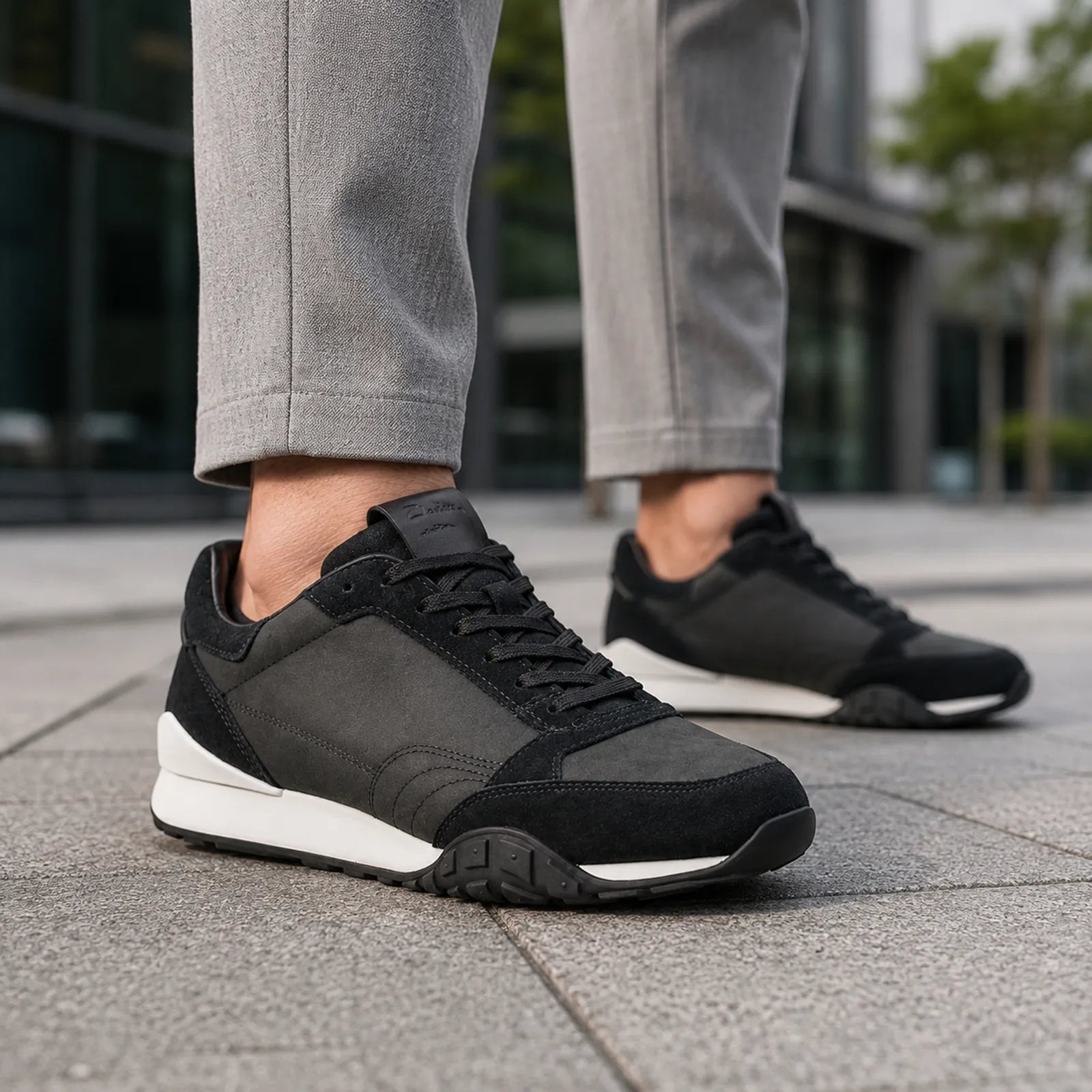 Men's black lace-up sneakers with padded collar, white midsole, textured rubber outsole