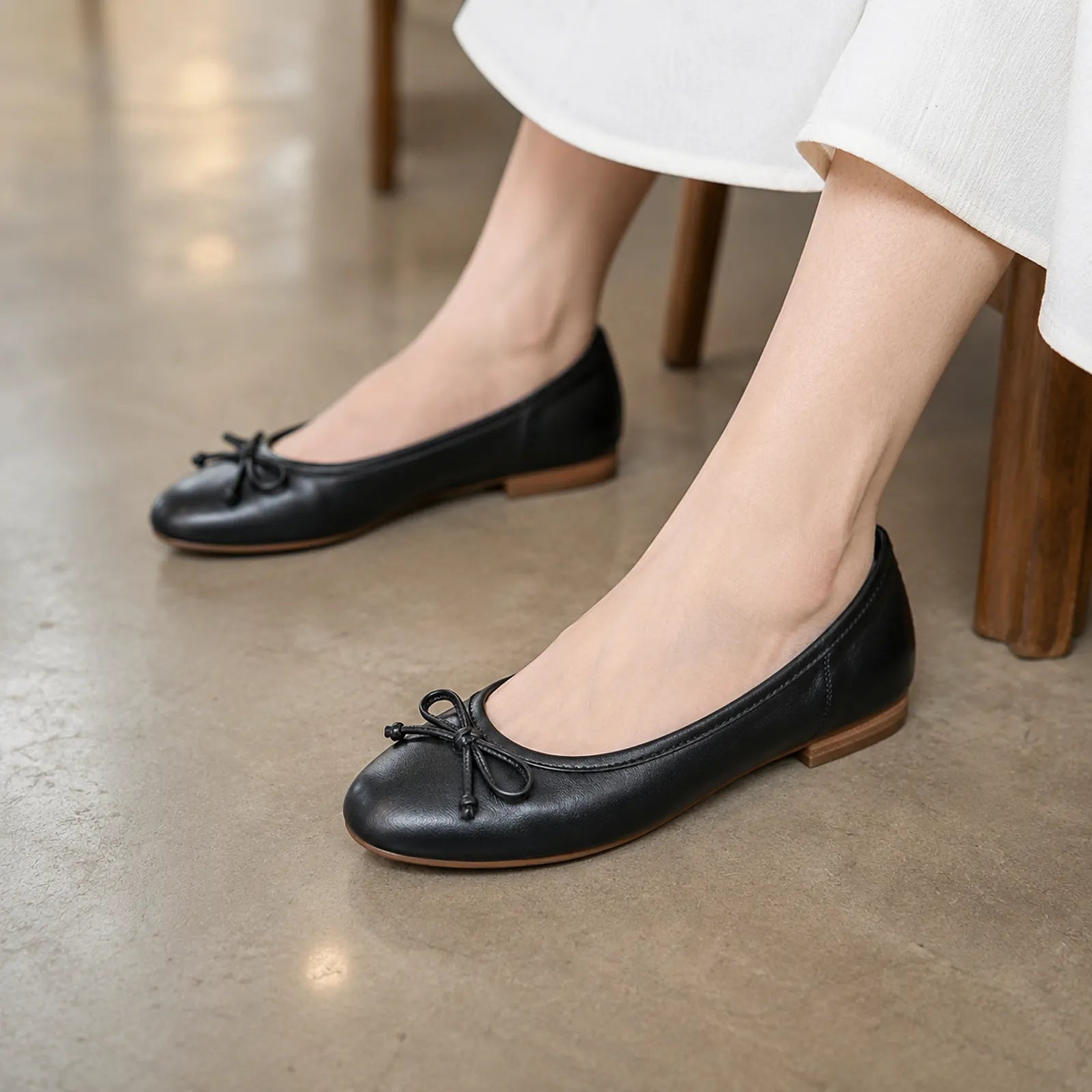 Women’s black leather loafers with bow at the toe and low block heel