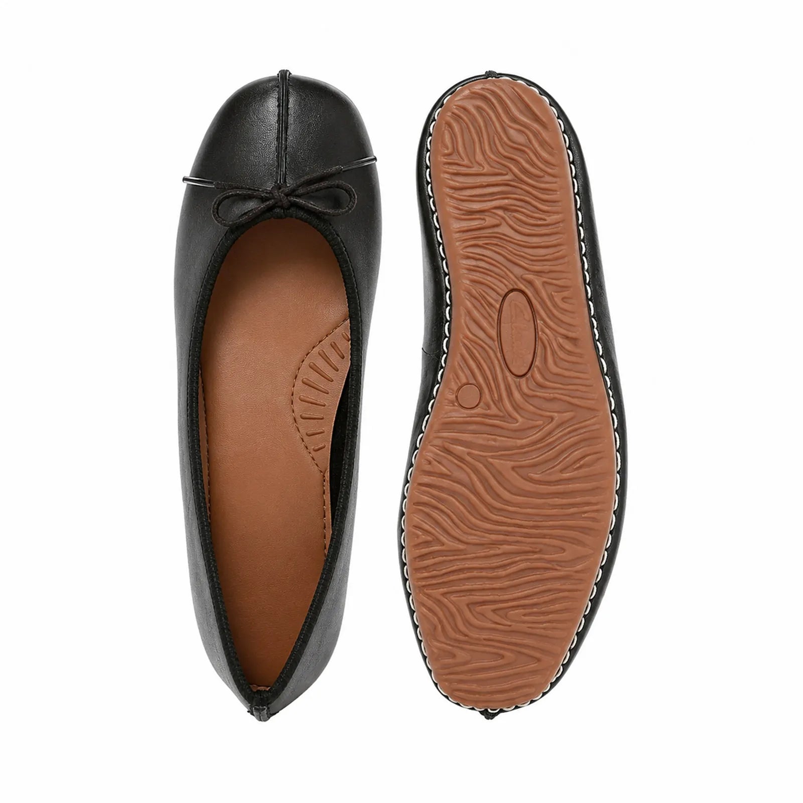 Black leather flats with bow, showing top view and textured outsole underside