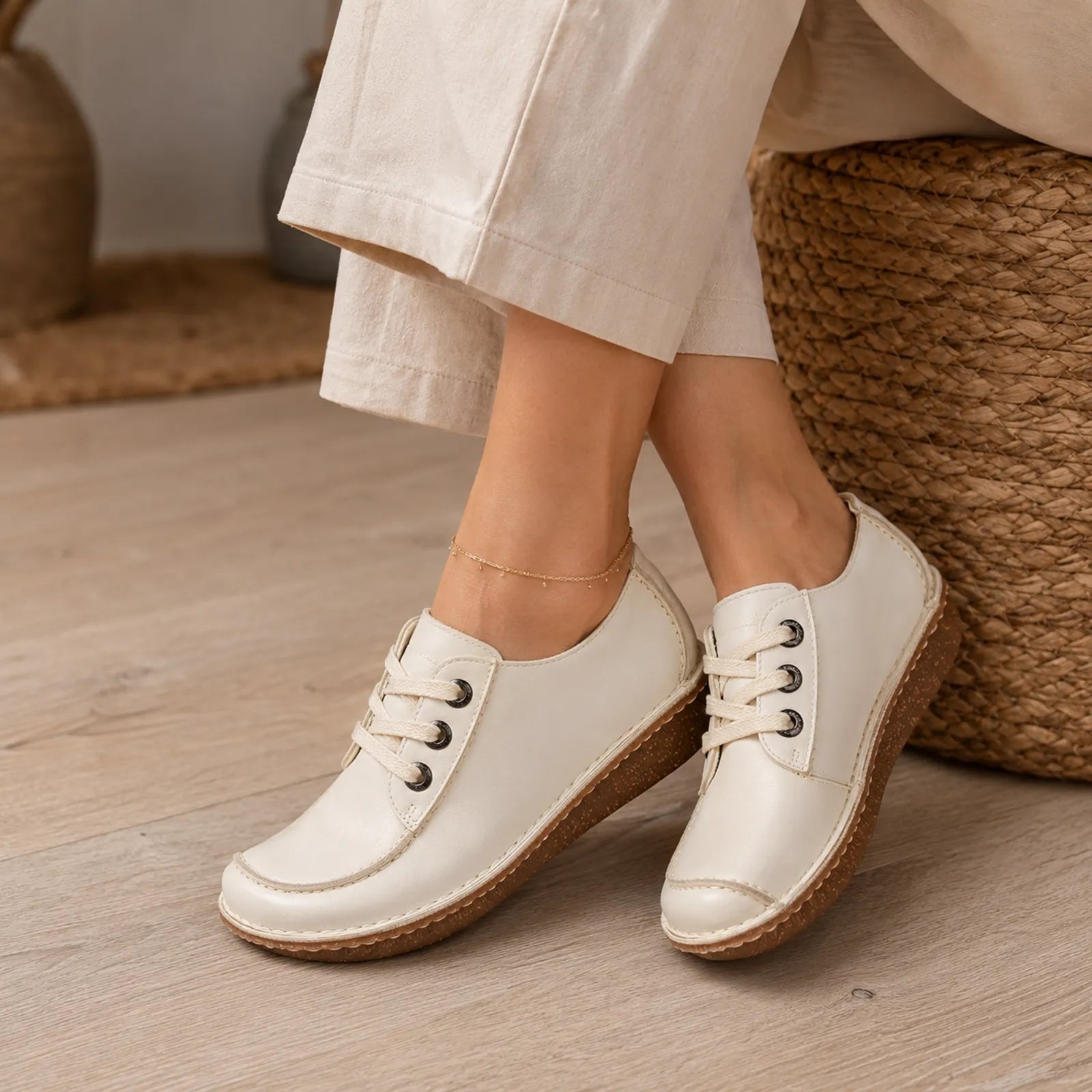 Beige women's leather lace-up shoes with white laces and textured outsole