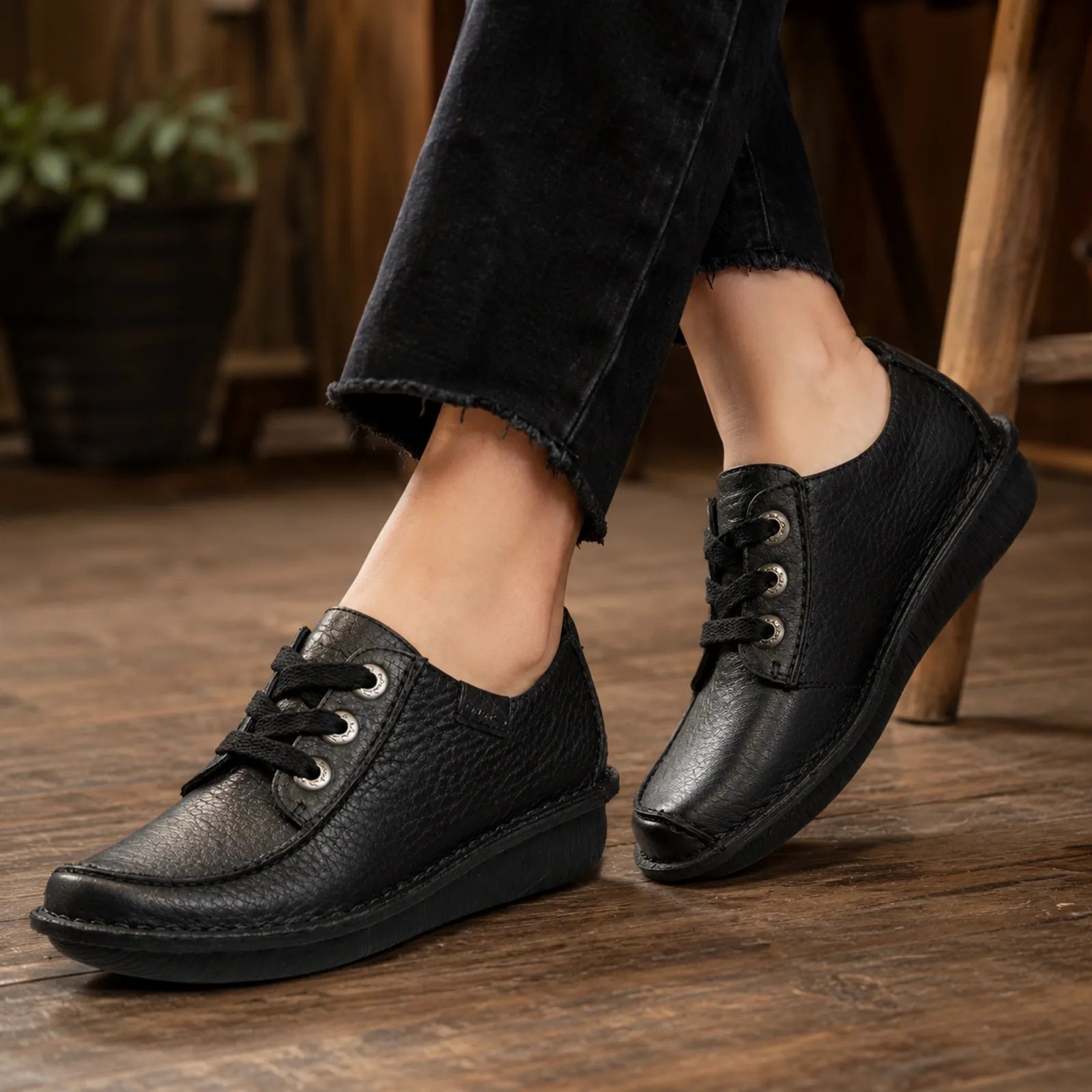 Black women's leather lace-up shoes with textured upper and low platform sole