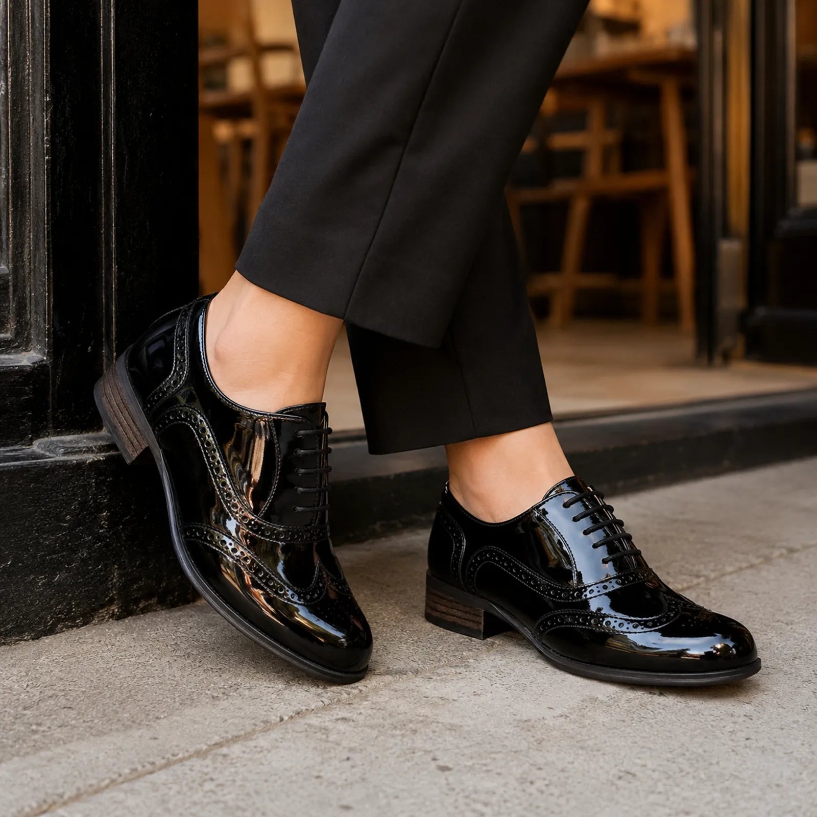 Black glossy brogue lace-up shoes with wingtip detailing and low block heel