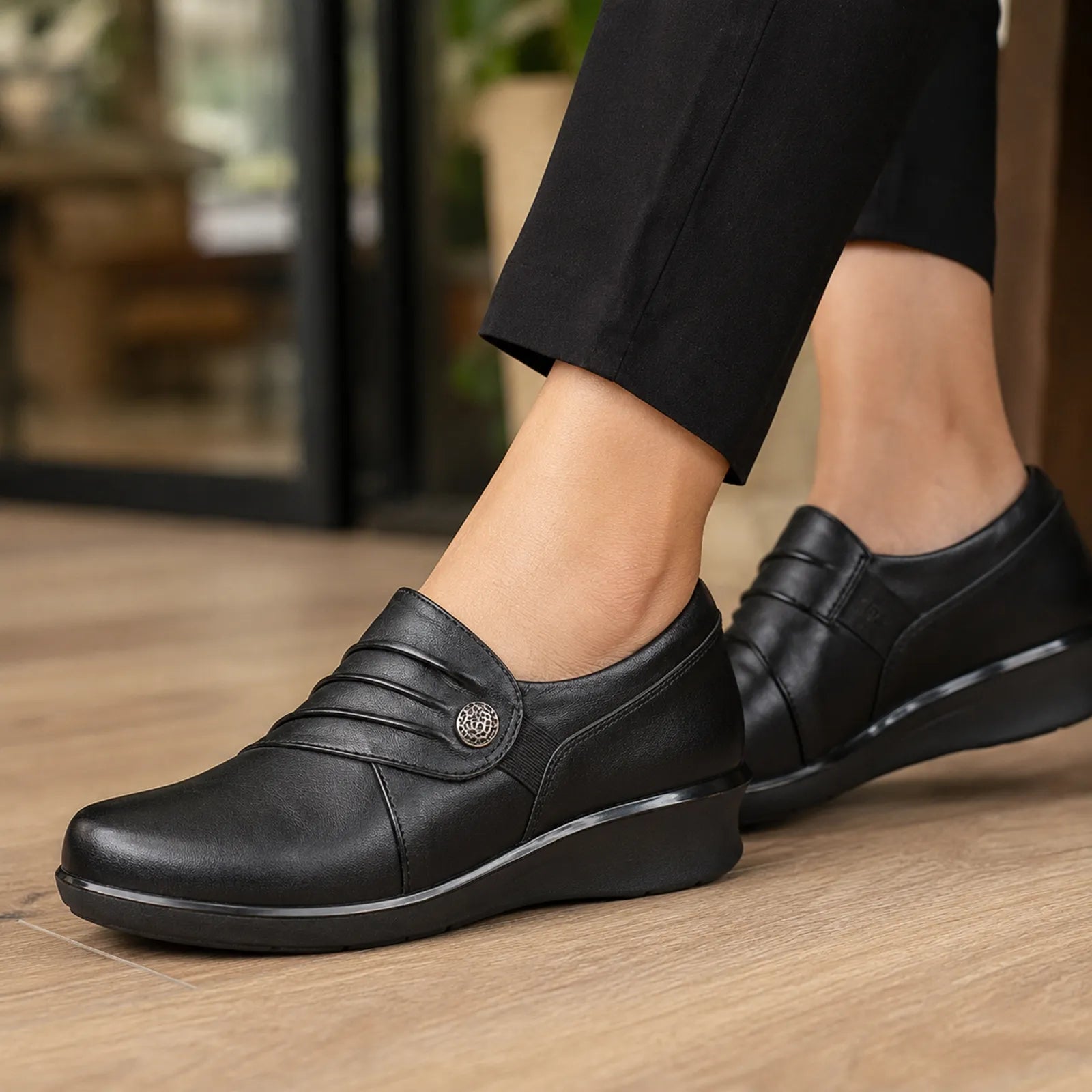 Black leather slip-on loafers with elastic panel detail, close-up