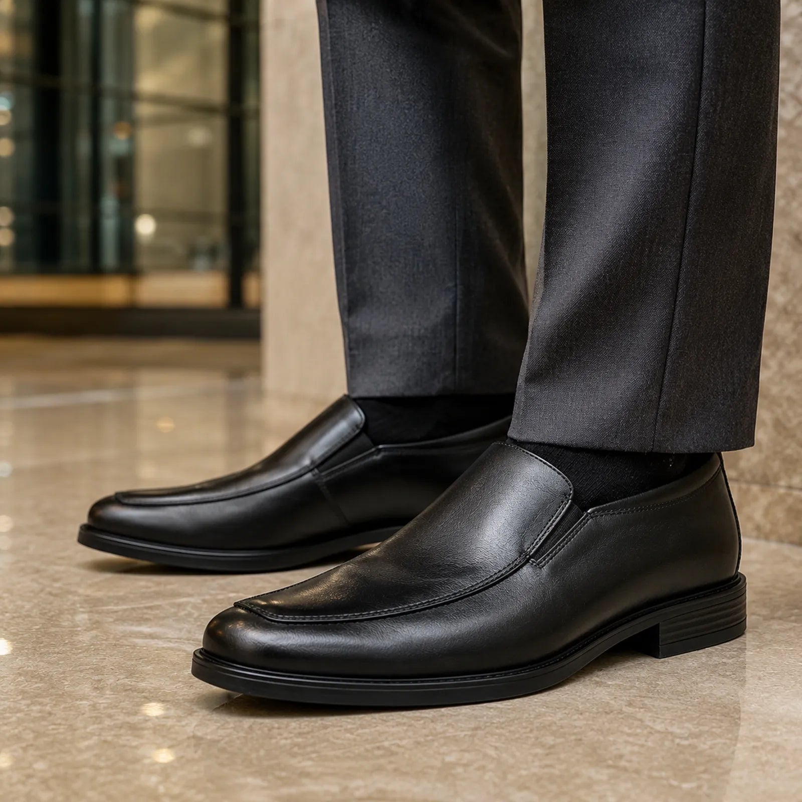 Black leather slip-on business shoes with stitched apron and low block heel