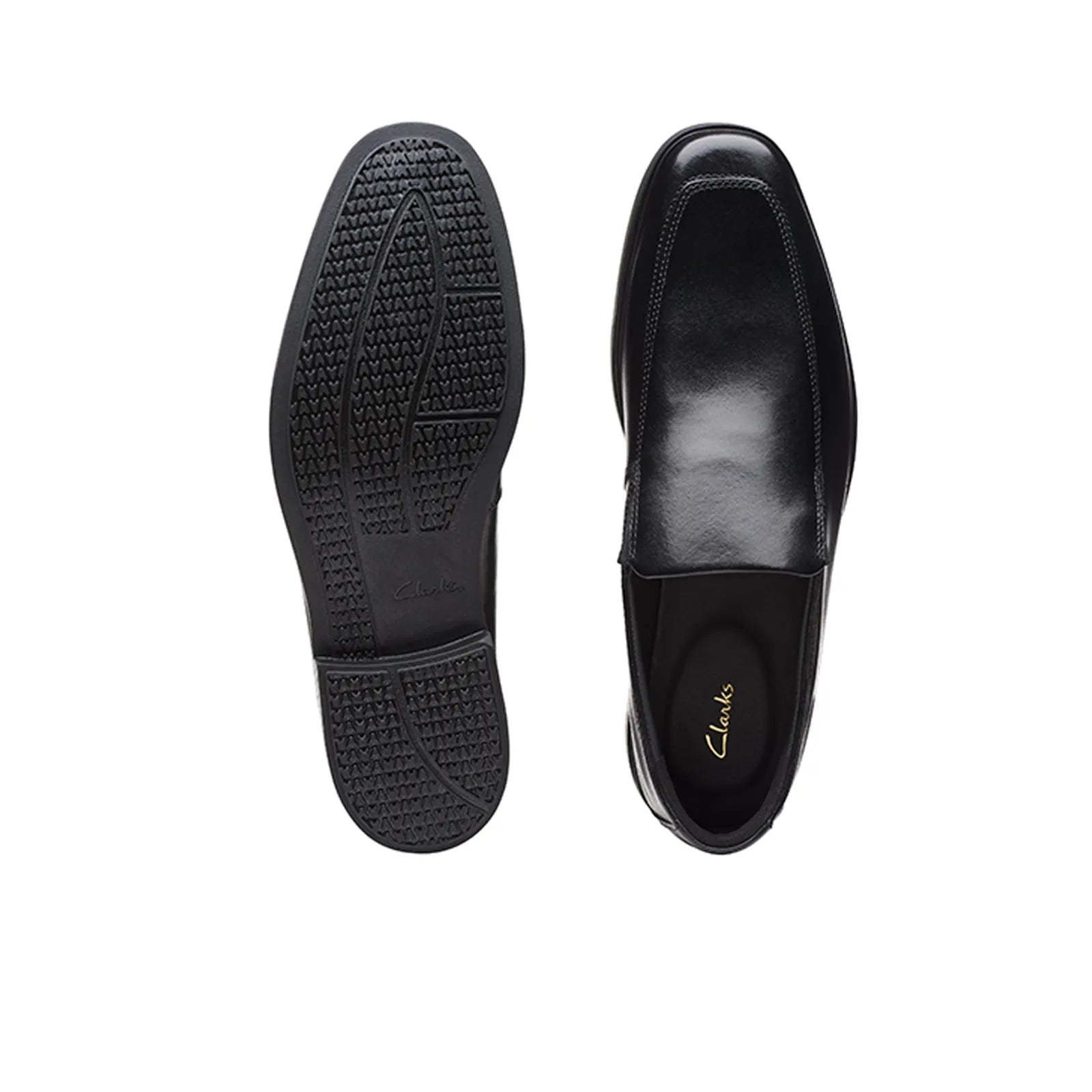 Black leather slip-on business shoes, showing treaded outsole and inner lining