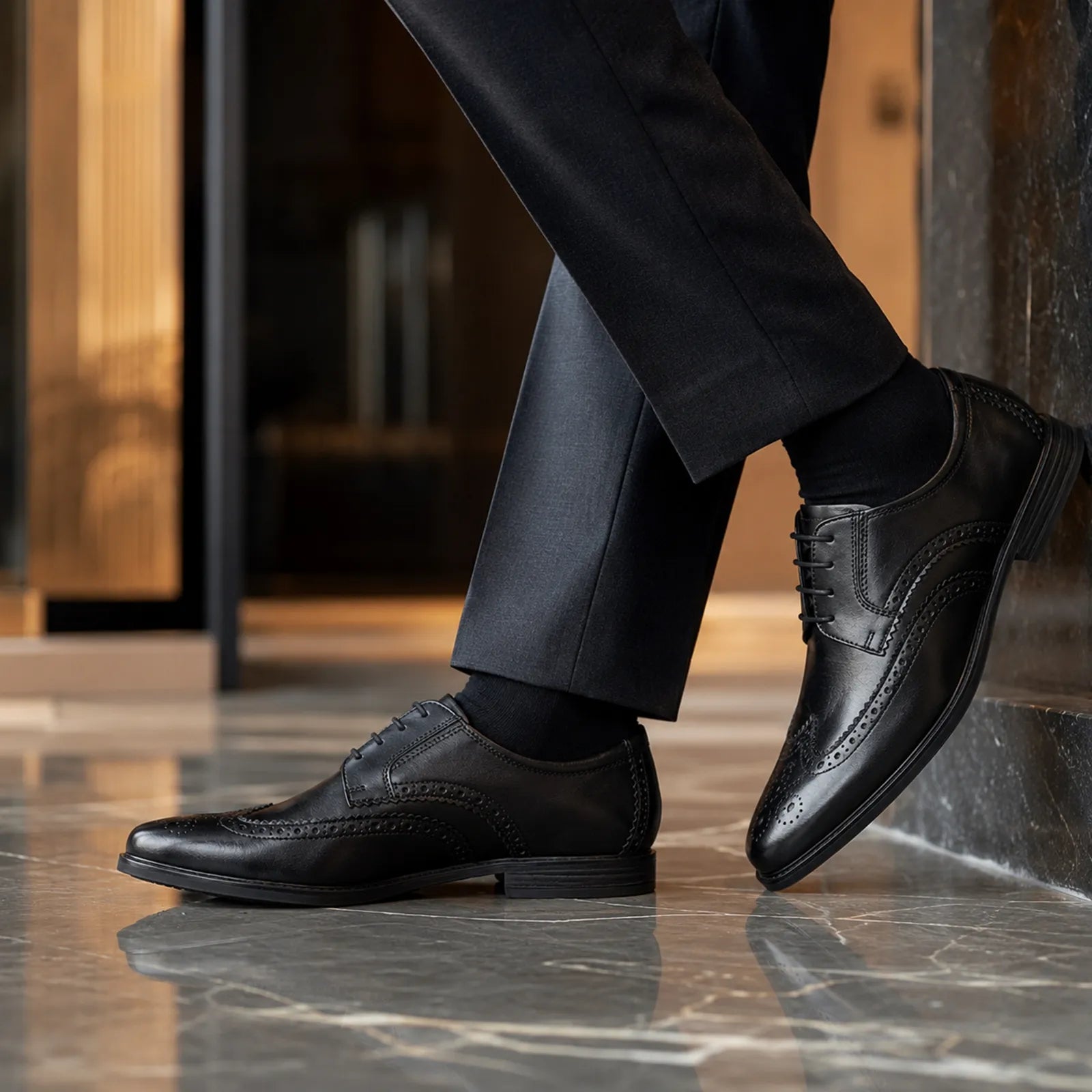 Black leather brogue derby shoes with lace-up front and decorative wingtip perforations