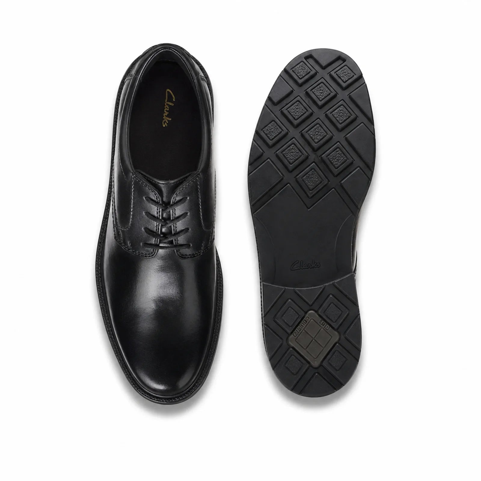 Pair of black leather lace-up business shoes with outsole view