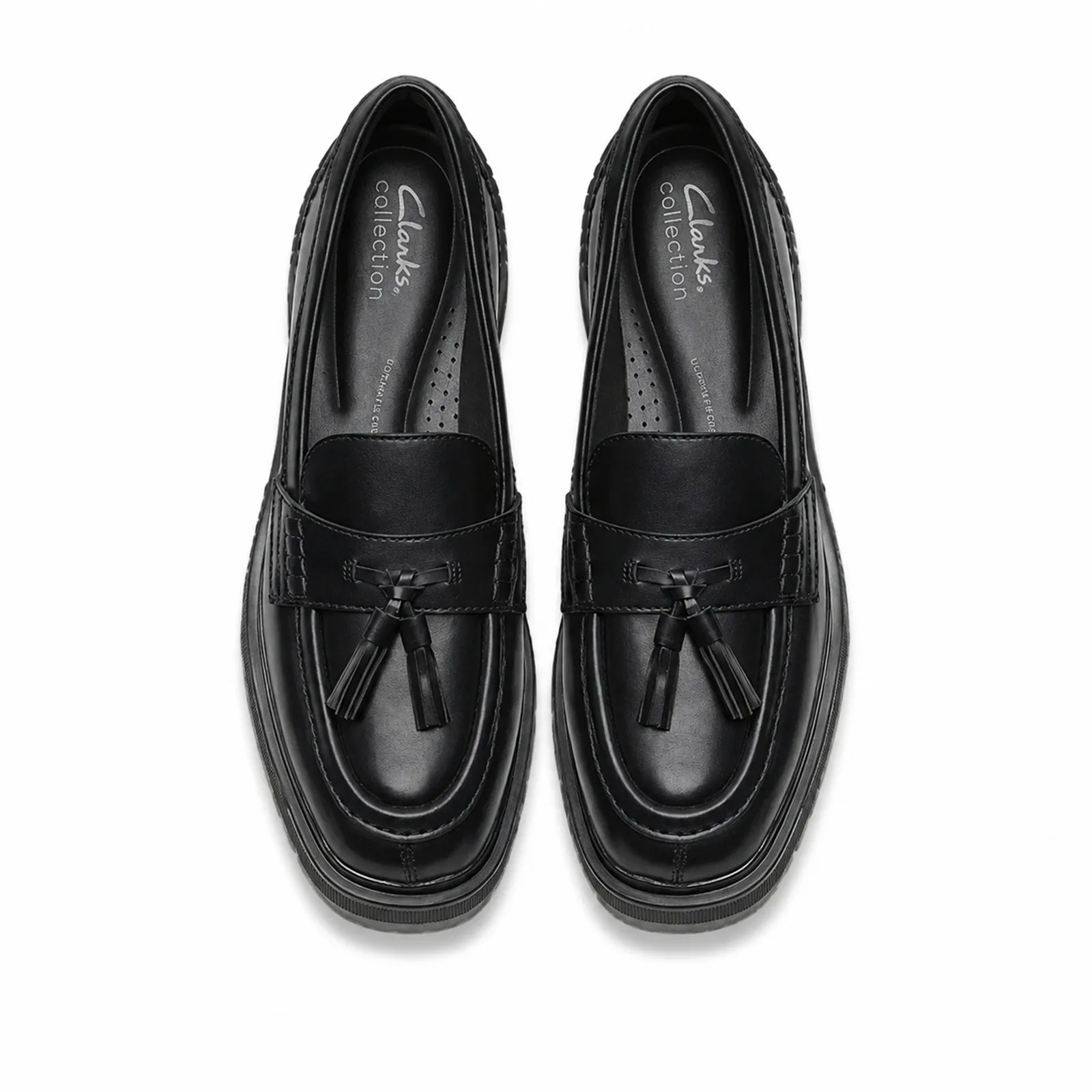 Pair of women's black leather tassel loafers, top view with tassels