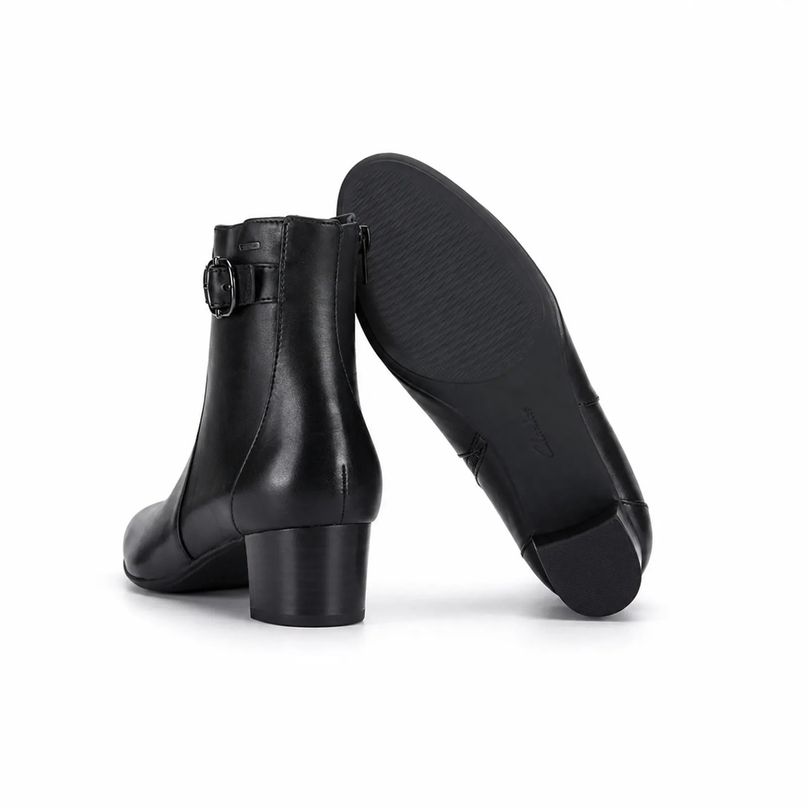 Black leather ankle boots with block heel, angled studio view