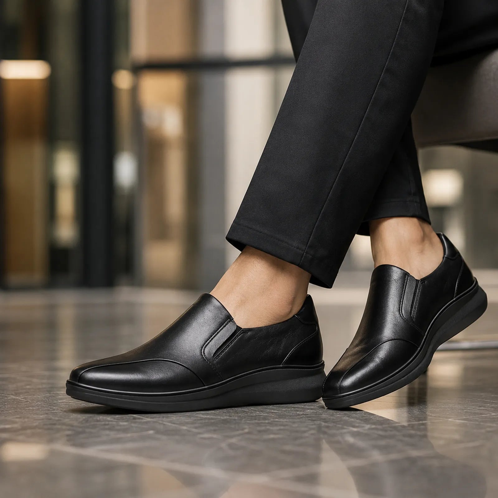 Black leather slip-on shoes with low wedge sole and side seam details