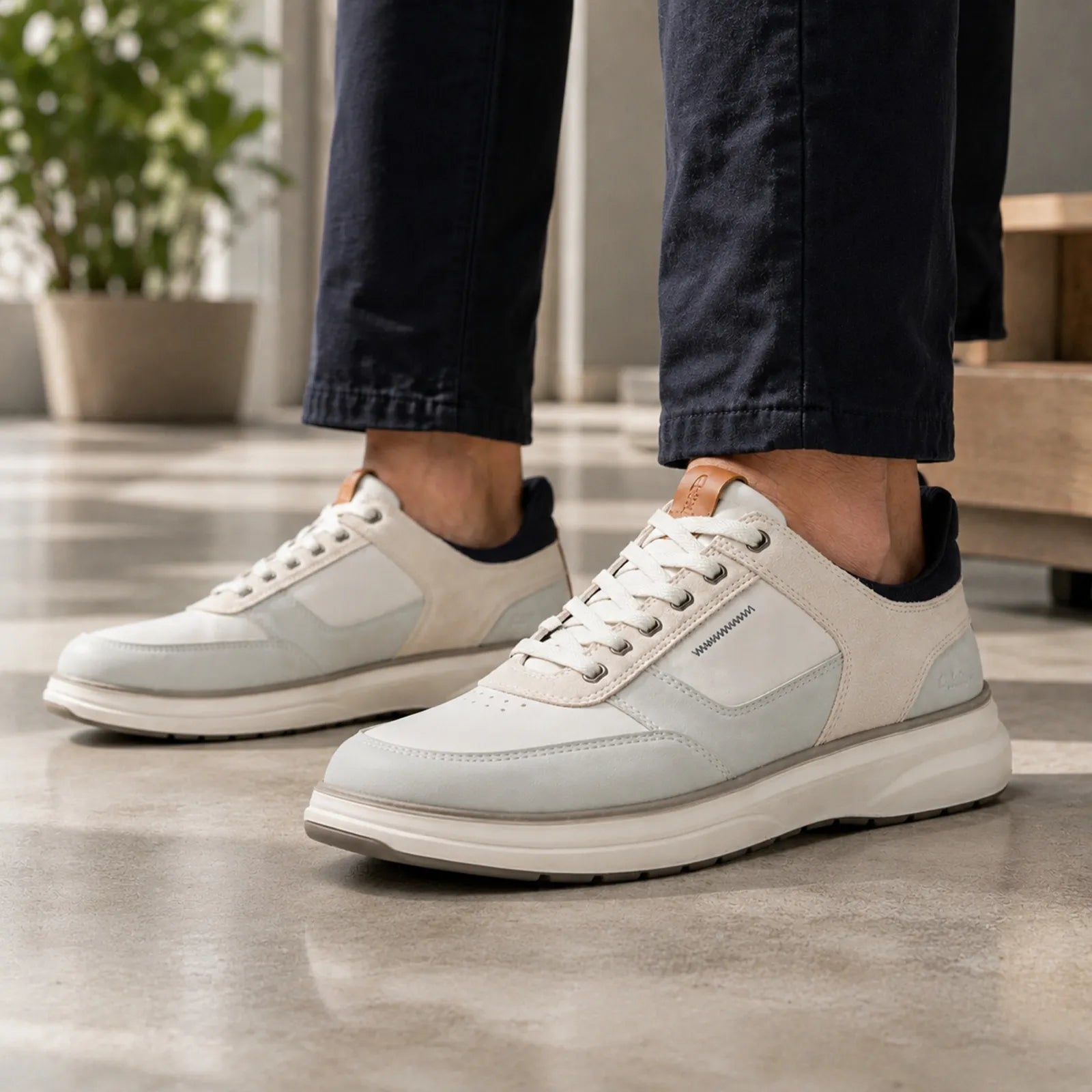 Cream leather sneakers with lace-up front and low-profile rubber sole