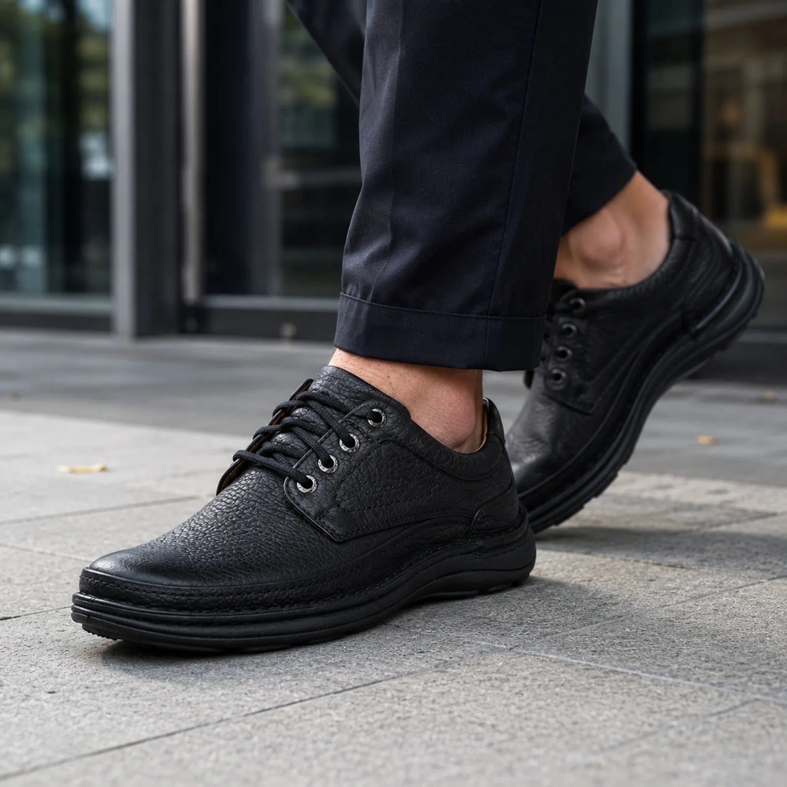 Men’s black leather lace-up shoes with textured upper and thick comfort sole