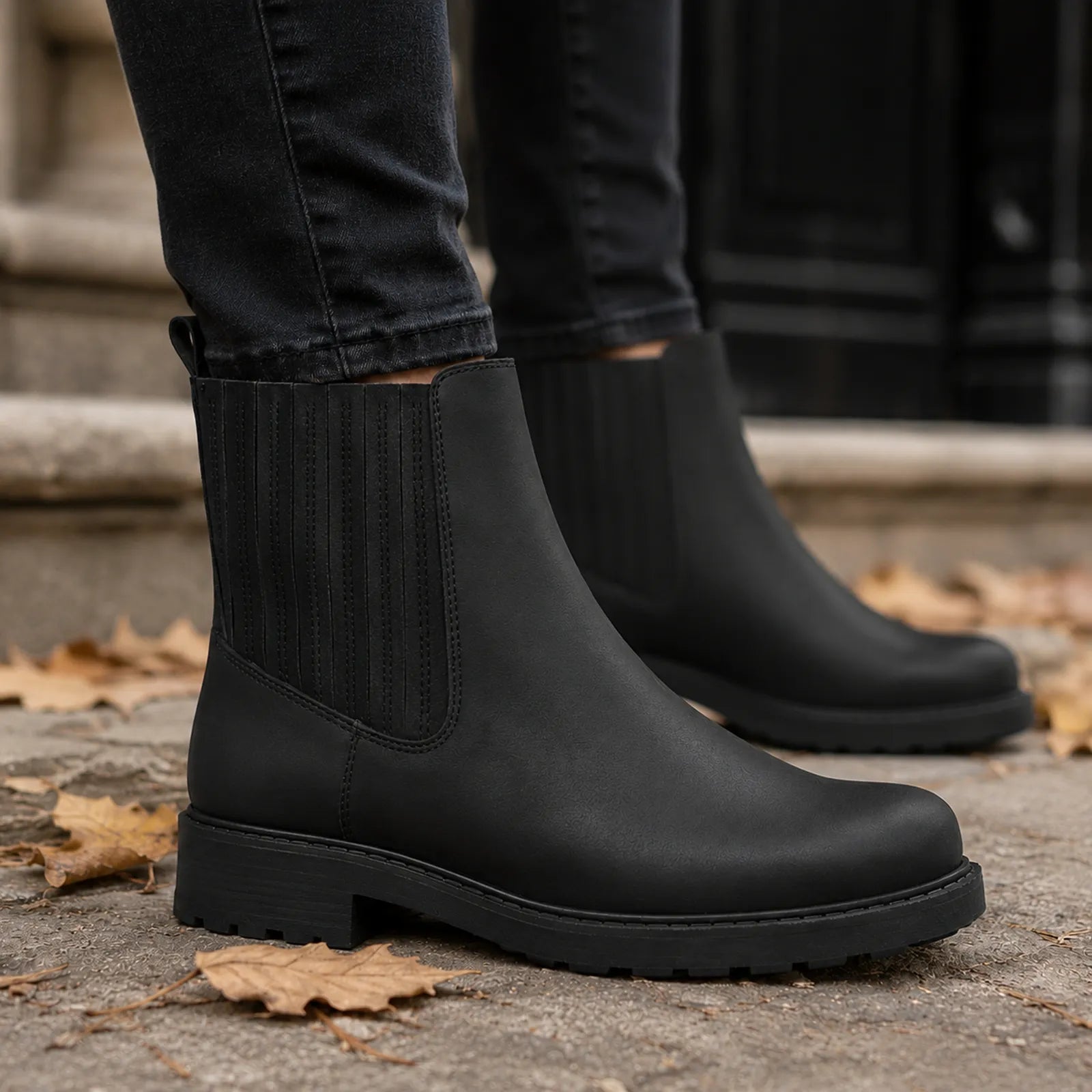 Black leather mid boots with elastic gore panels and chunky tread sole