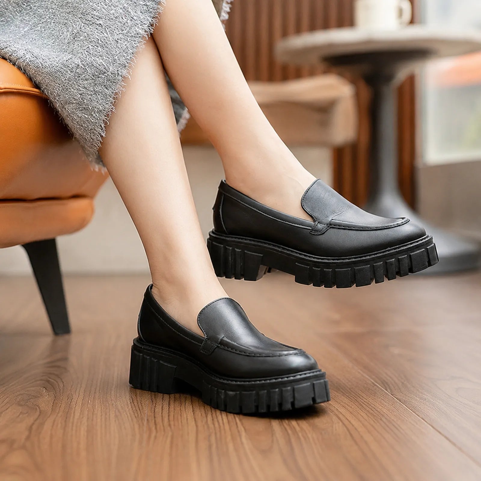 Black leather slip-on loafers with chunky platform sole and low block heel