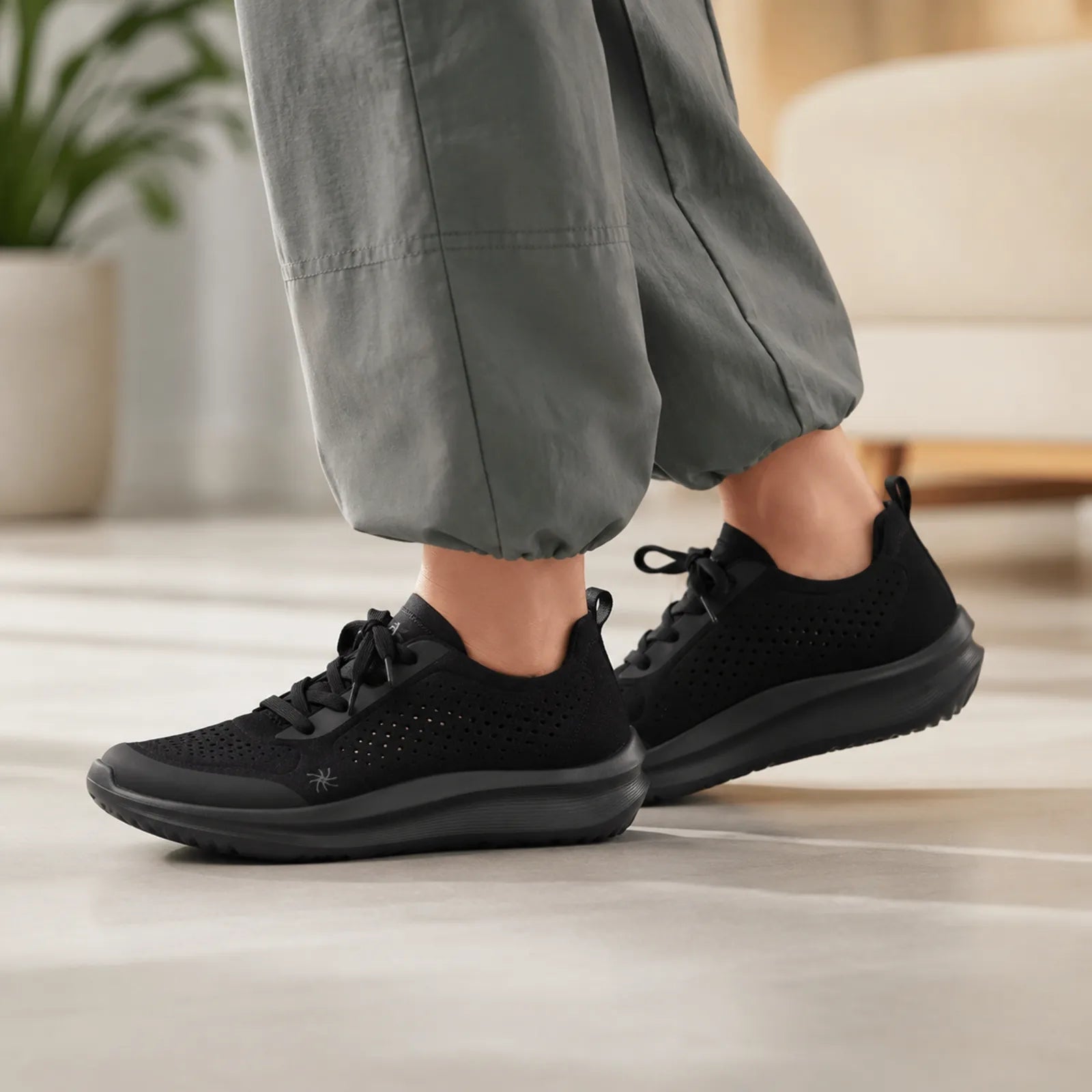 Women's black lace-up sneakers with perforated upper and rounded toe