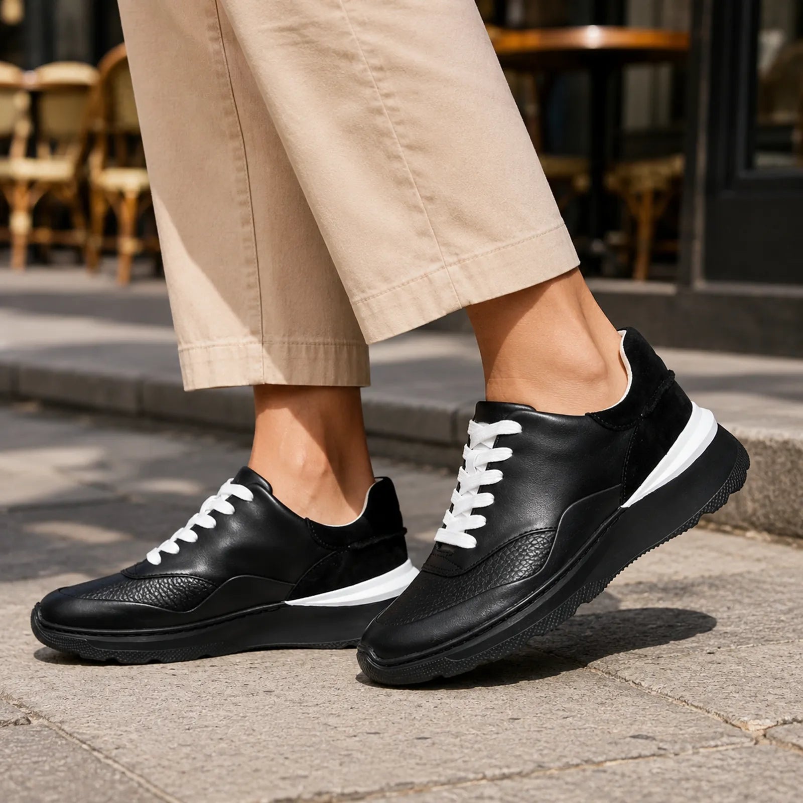 Women's black leather lace-up sneakers with white laces and contrast sole