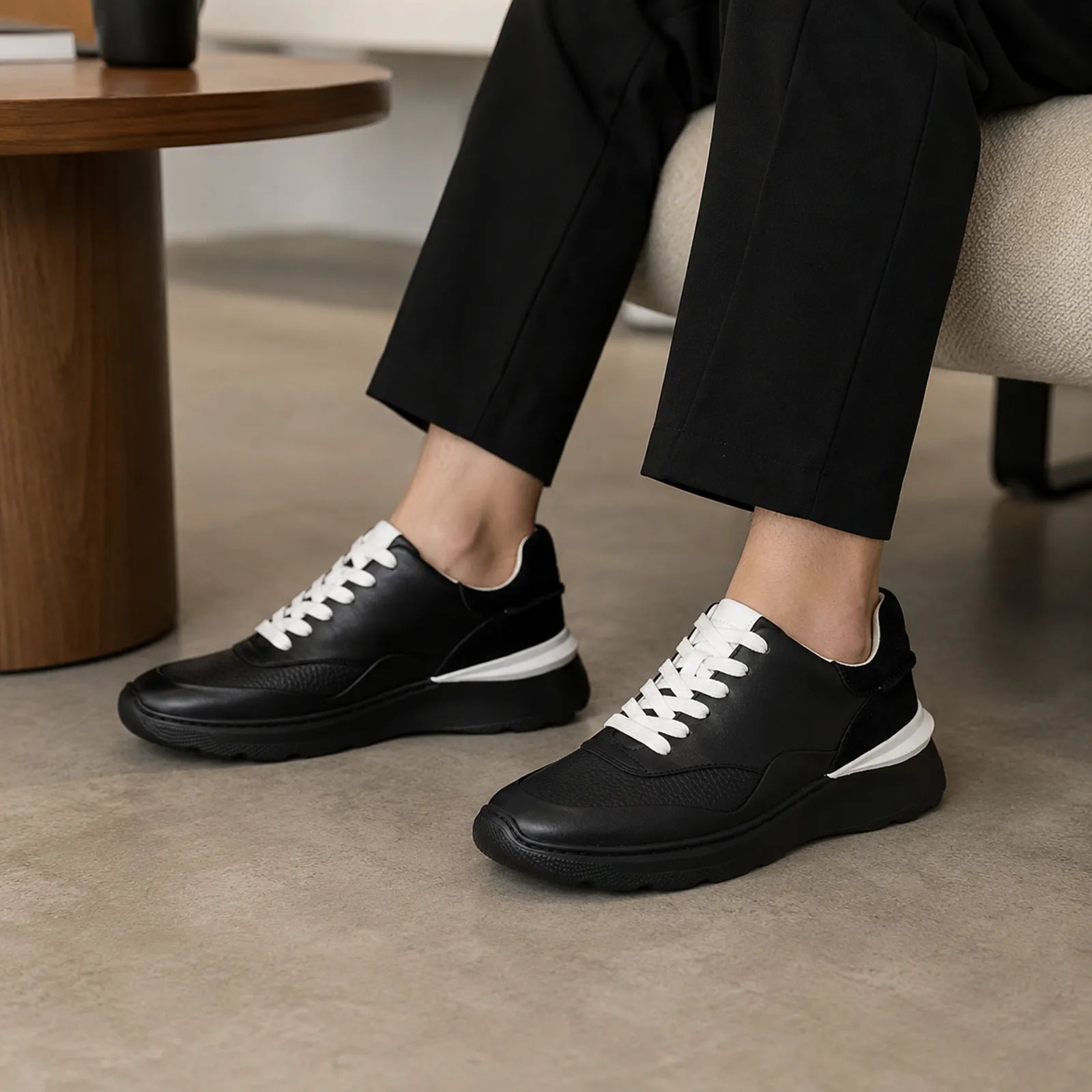 Women's black leather lace-up sneakers with white laces and chunky sole