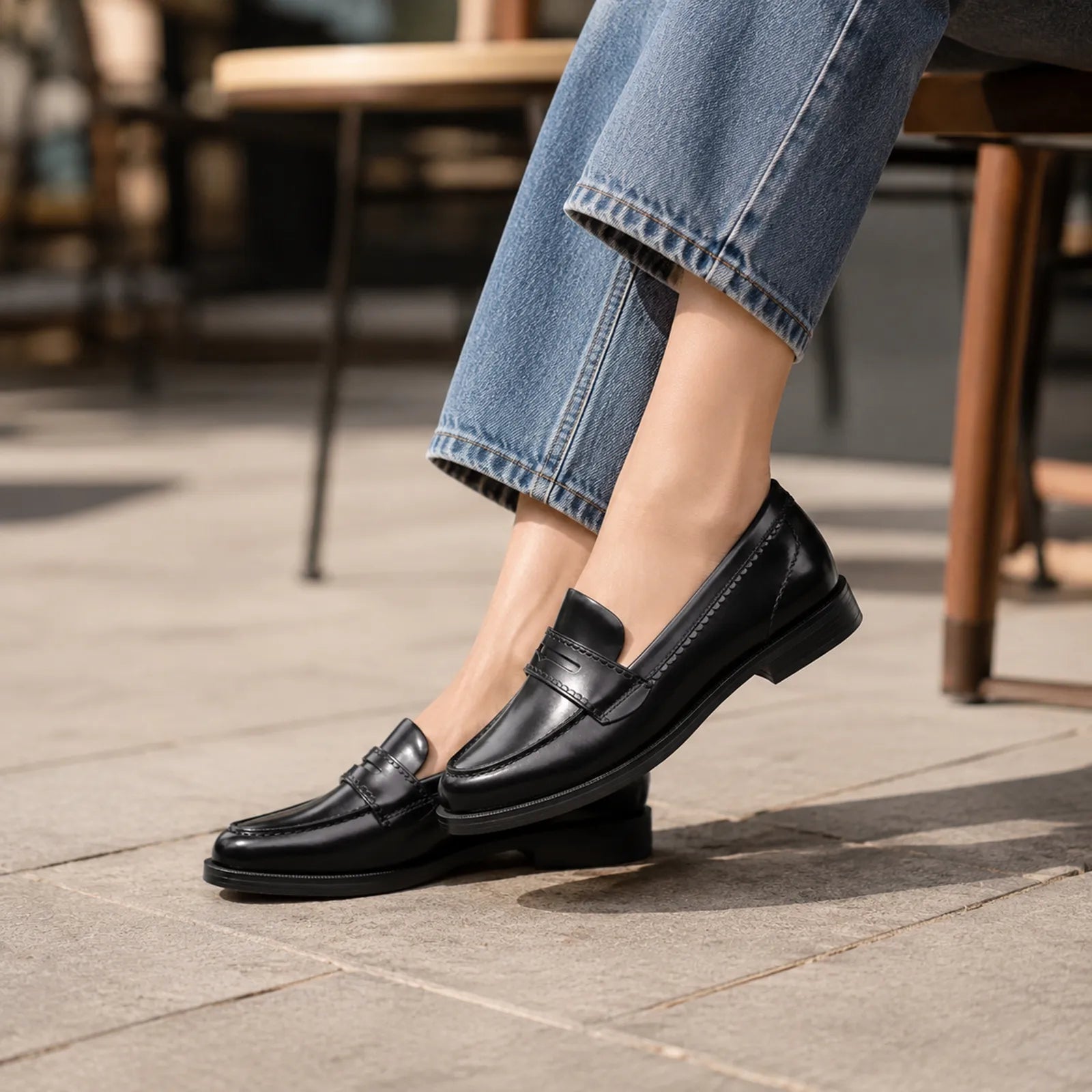 Women’s black leather loafer with strap and penny vamp stitching