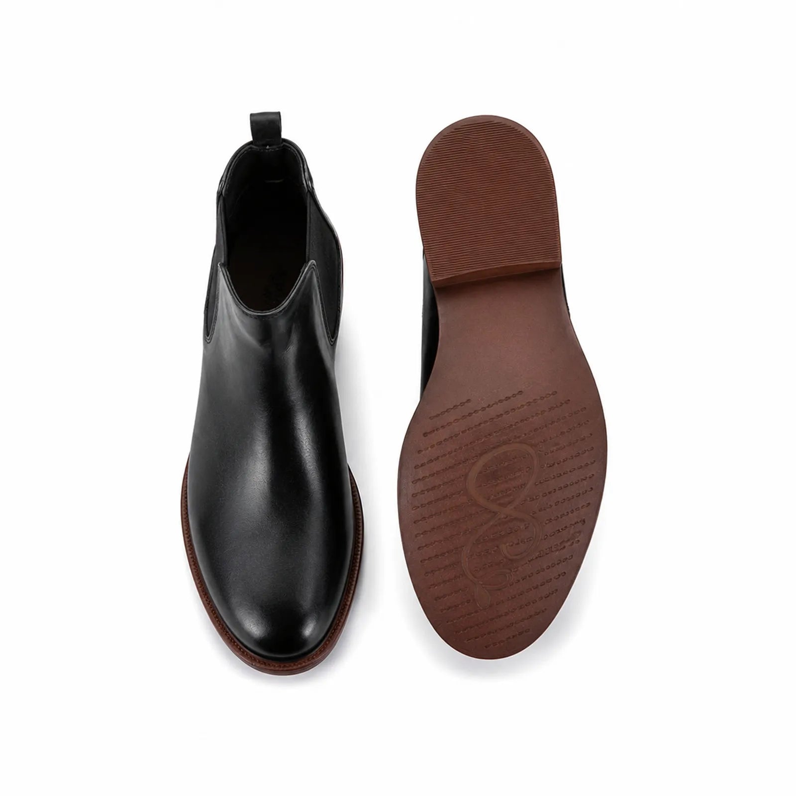 Pair of women's black leather Chelsea boots, one showing outsole bottom view