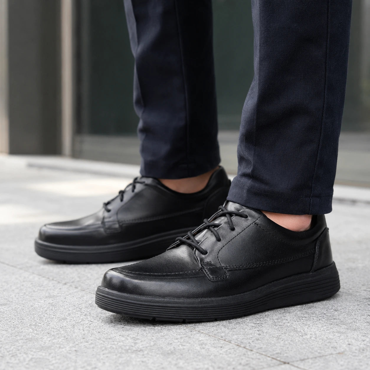 Black leather lace-up business shoes close-up with thick rubber sole