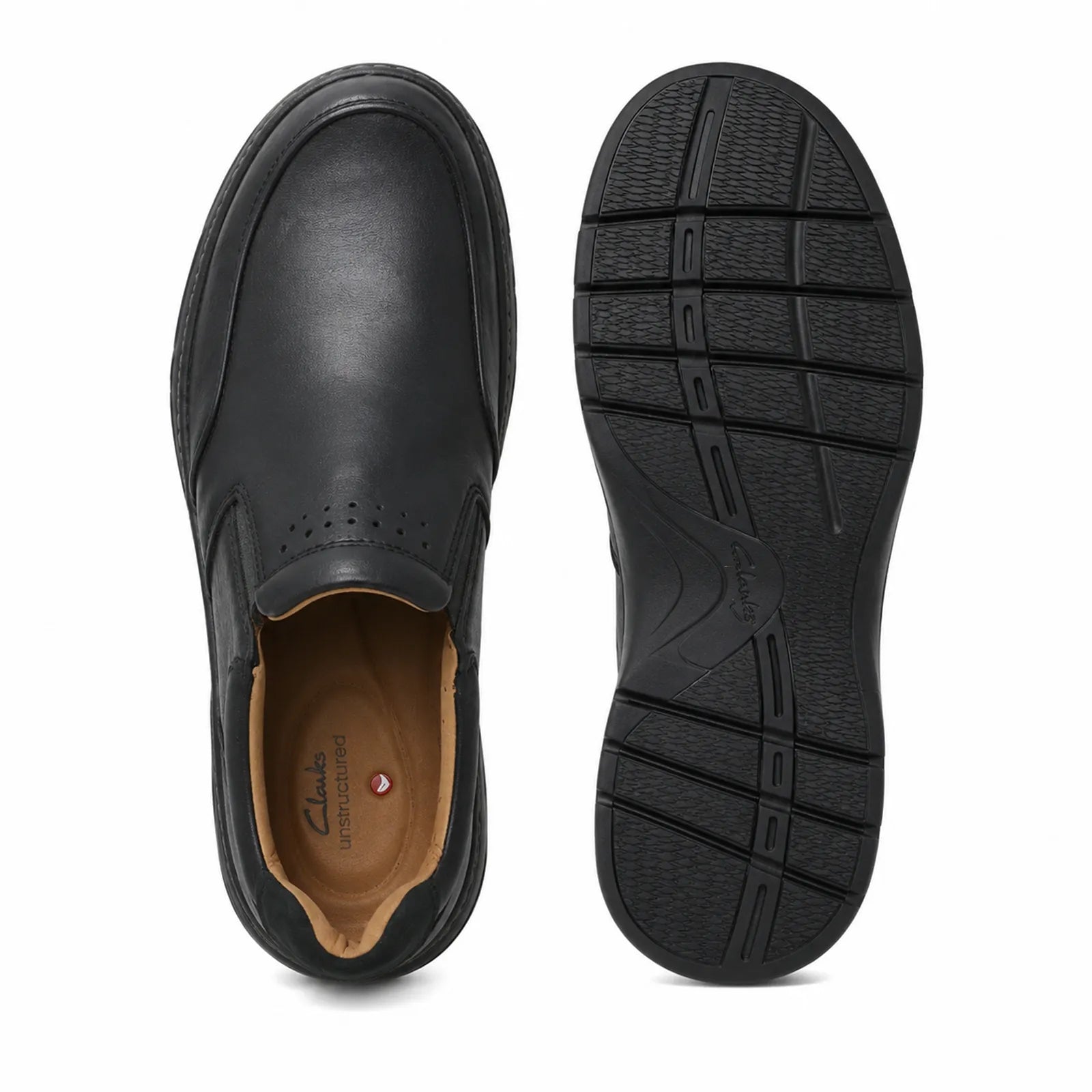 Pair of black leather slip-on dress shoes: toe view and textured rubber outsole