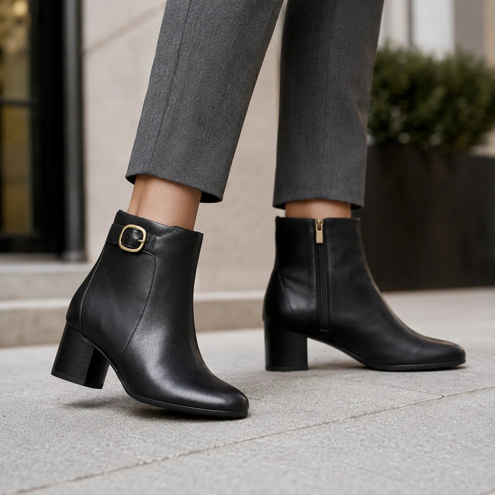 Black leather ankle boots with block heel and buckle strap detail
